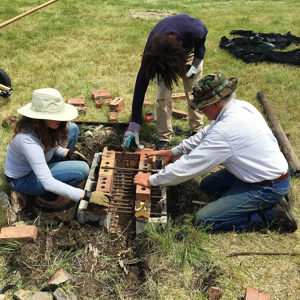 Community members work together to build a fire pit.