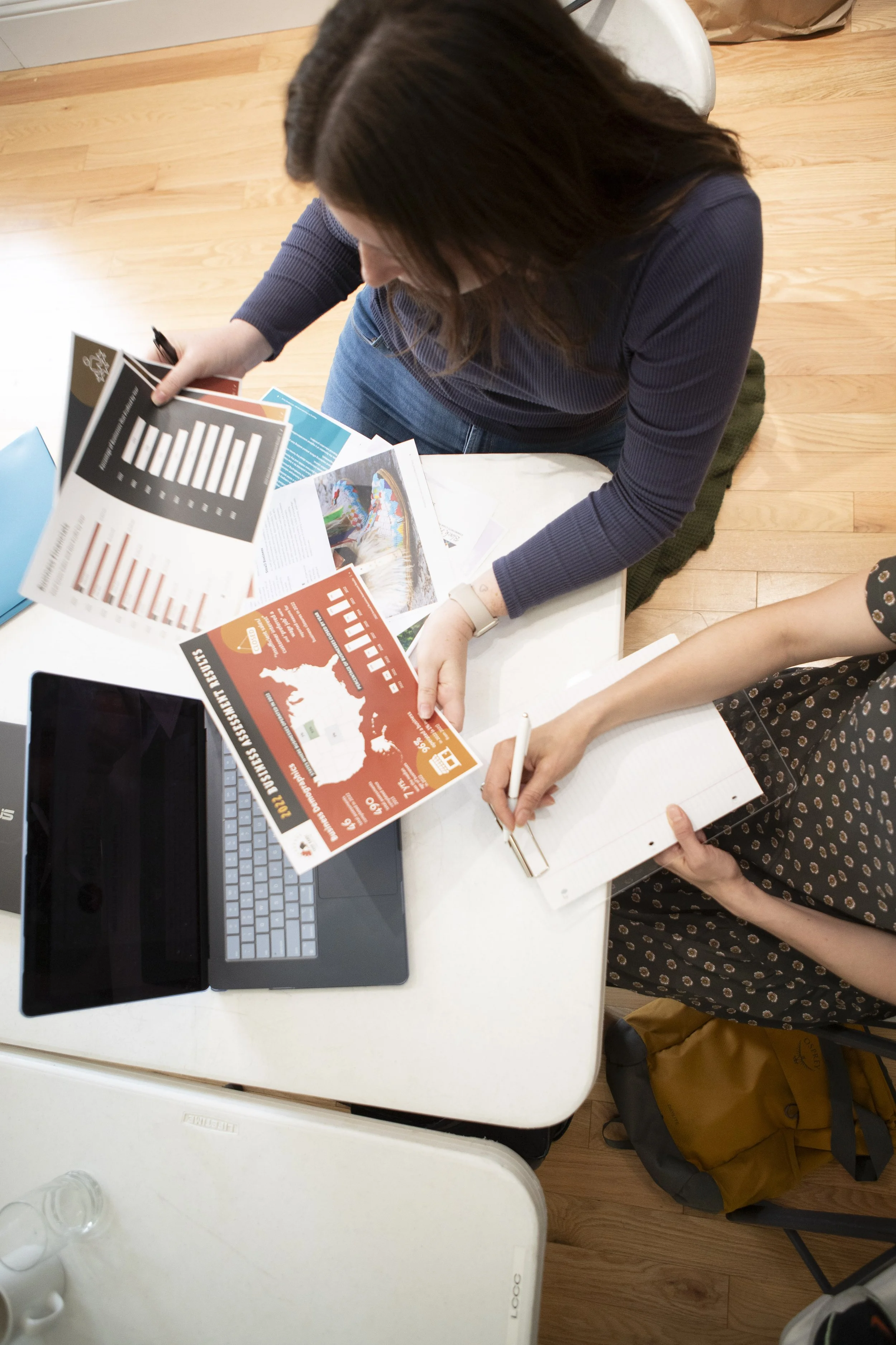 Colleagues discuss graphic design samples.