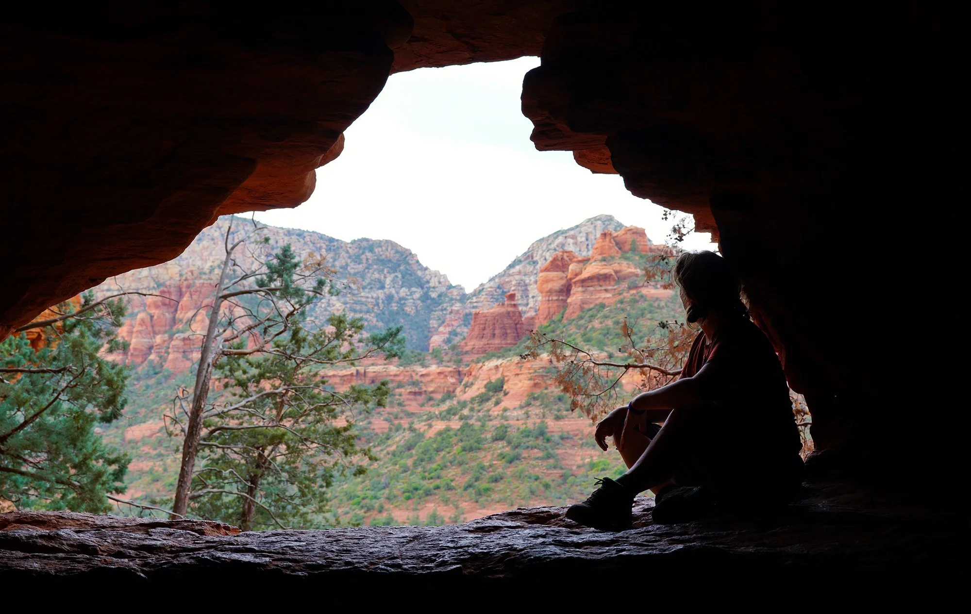 Susanna takes a break from hiking to enjoy the expanse of red rock outside Sedona, Arizona.