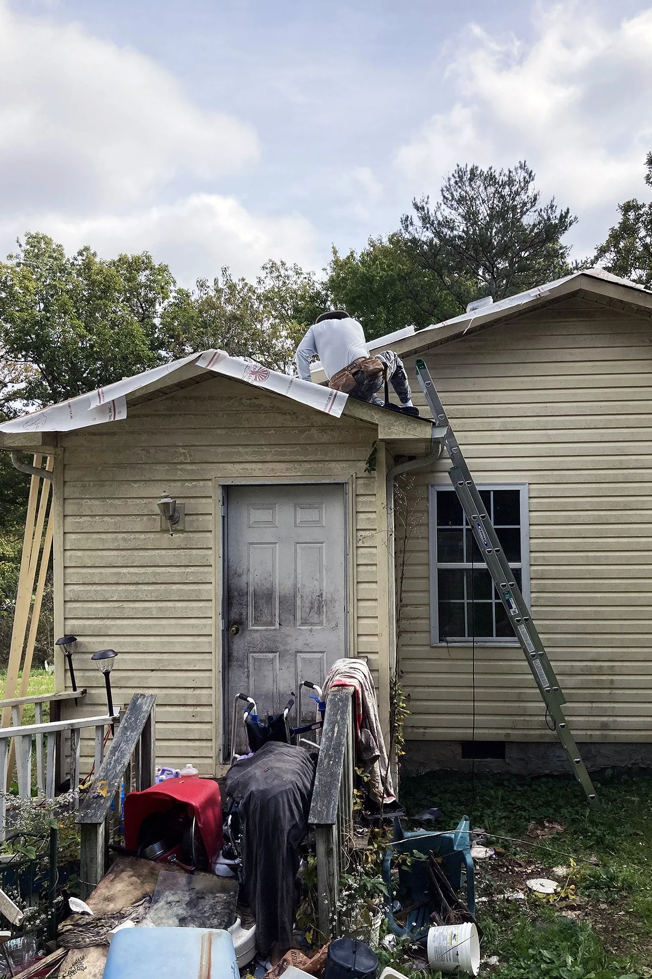 A Mountain T.O.P. volunteer adds underlayment before reroofing a home.