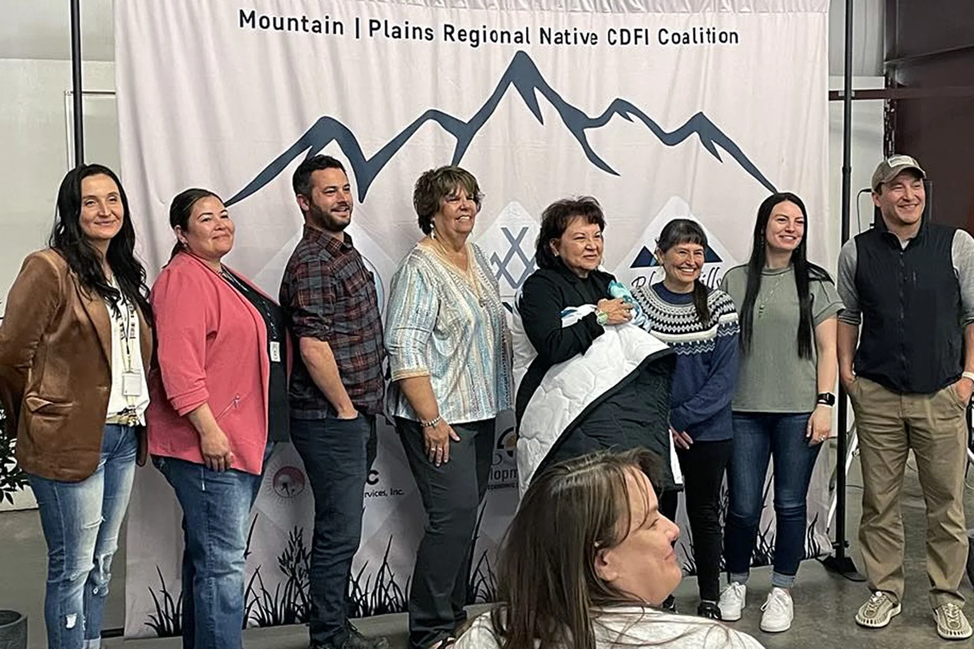 Angie Main is gifted a star quilt for hosting the Mountain Plains Regional Native CDFI Coalition gathering. Photo courtesy of NACDC.
