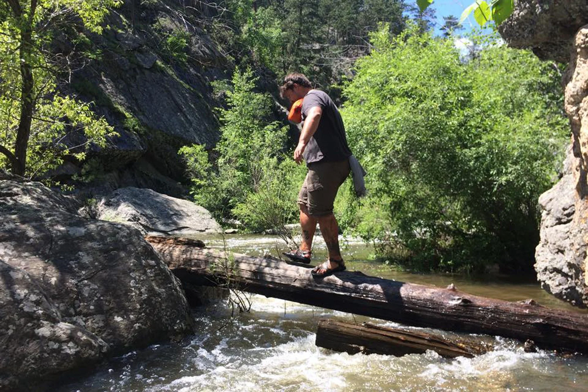 Josh traverses a stream during Sweet Grass field school in the Black Hills, South Dakota, in 2015.