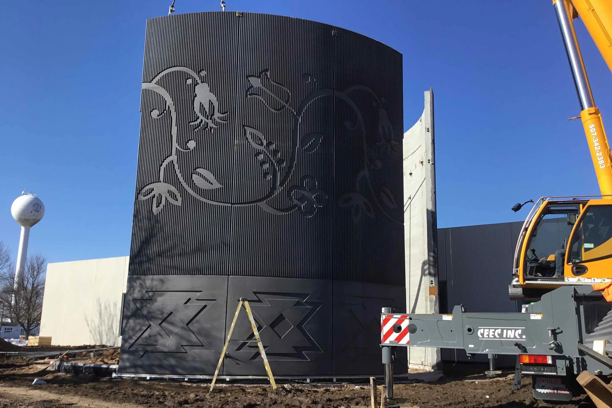 Artwork inspired by local works and produced by Walt Pourier adorn the concrete pillars that complete the round gathering space.