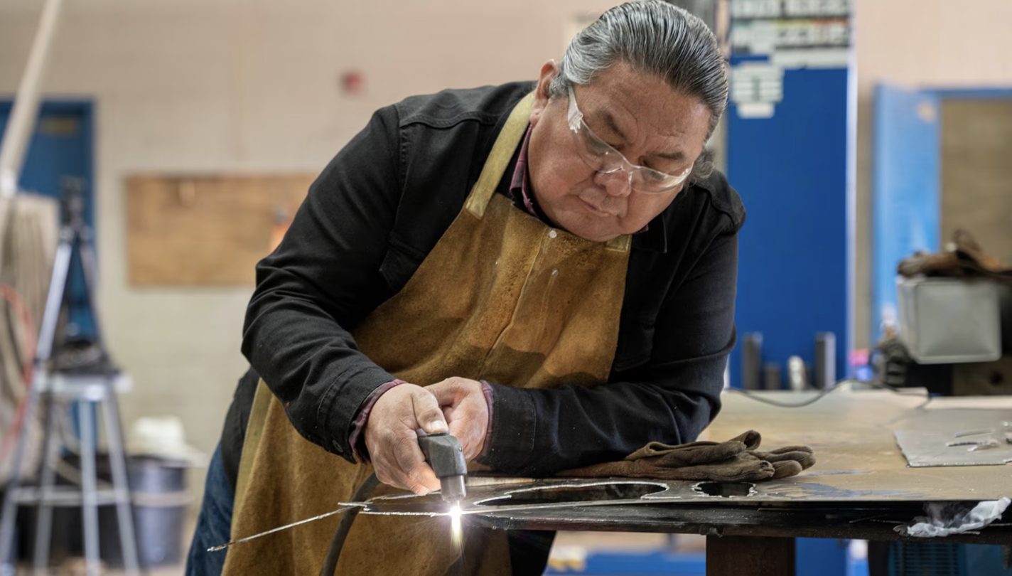 Man welding sheet of metal