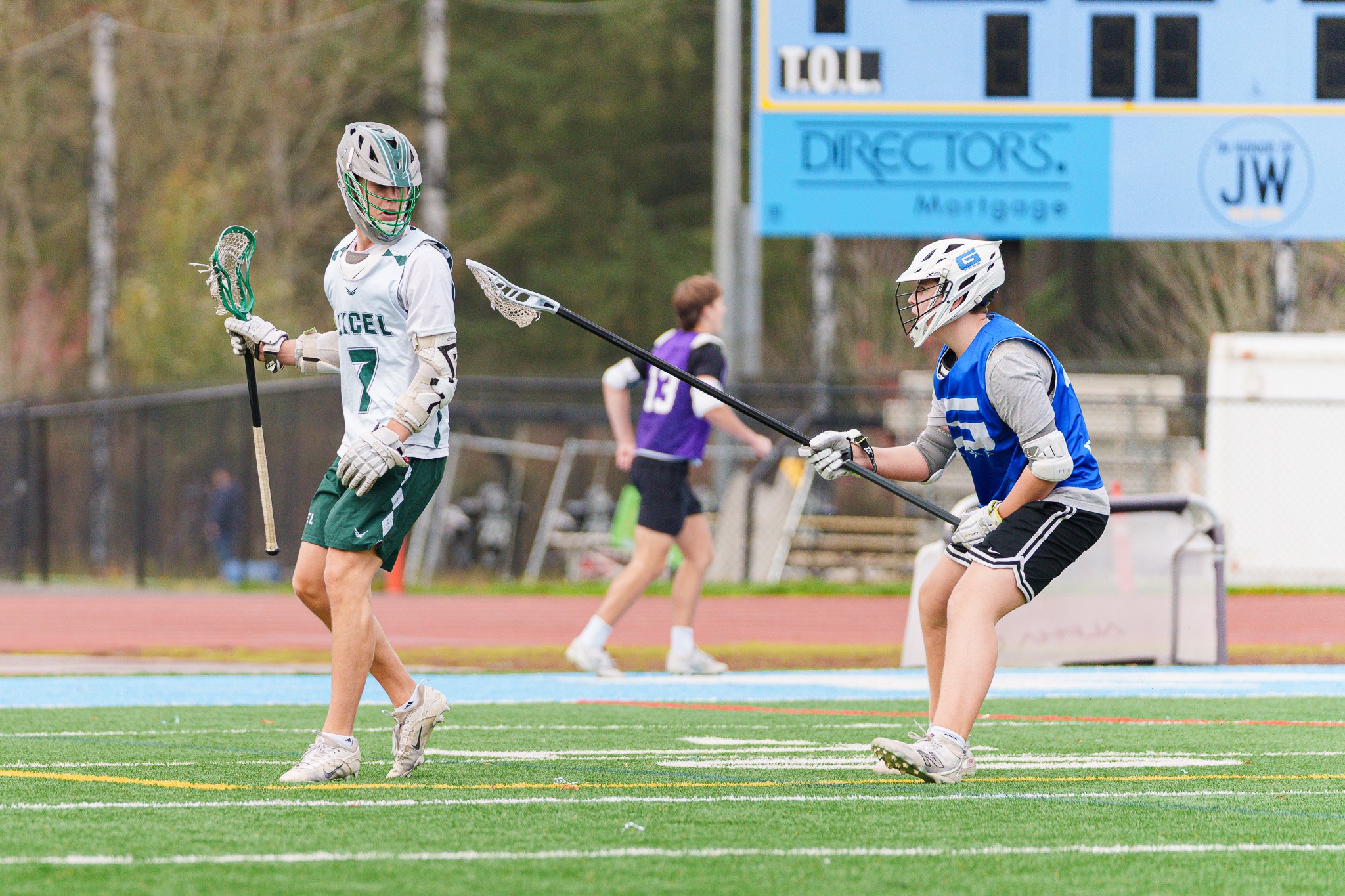 From my very humble of view, lacrosse sticks add so much dimension to an image (and quite frankly, can also wreak havoc, making some images unusable--I'm looking at you, defenders). In this photo, the defender's crosse adds an element of structure th