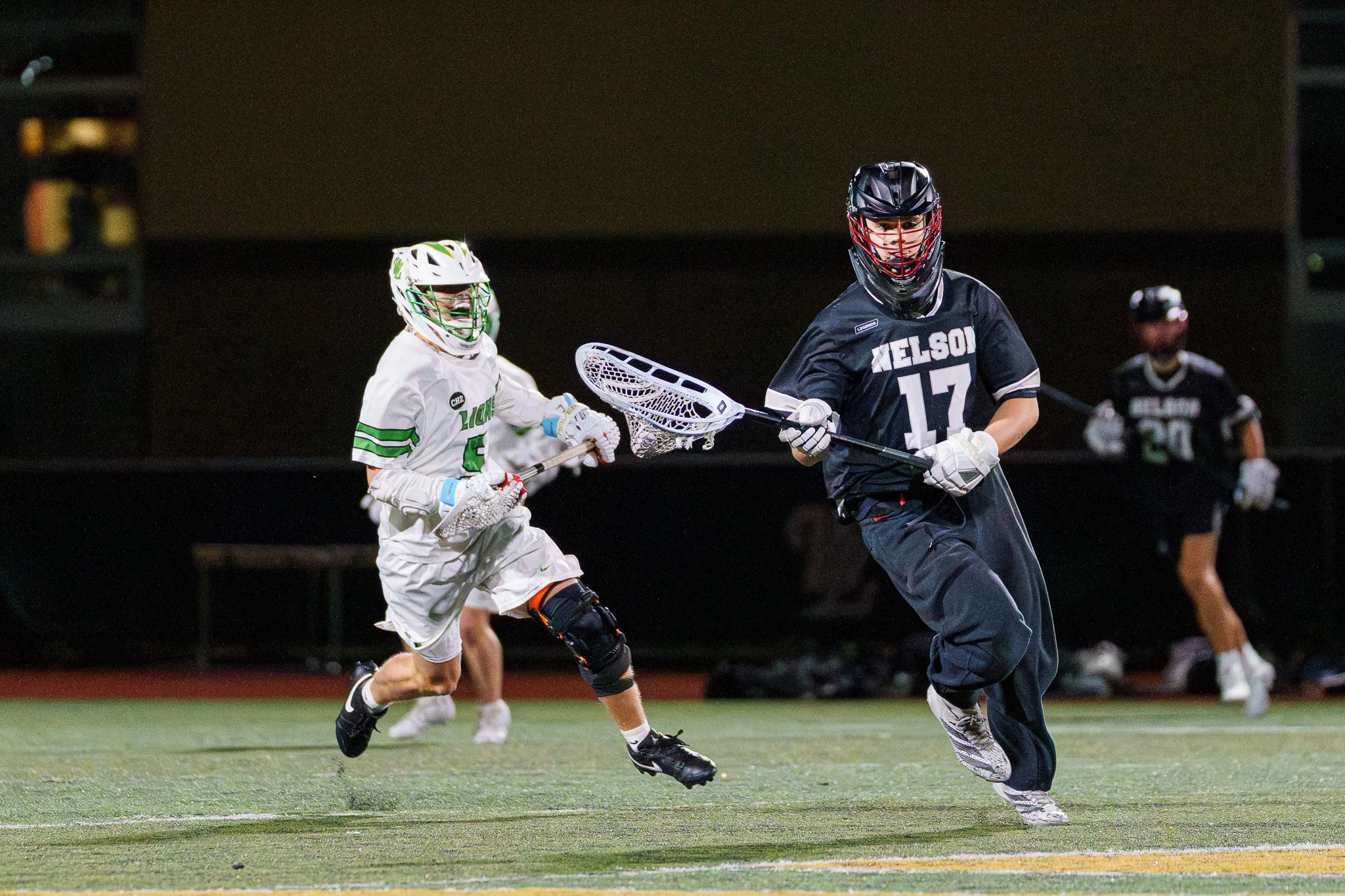 Multiple players converge during a high school lacrosse tournament.