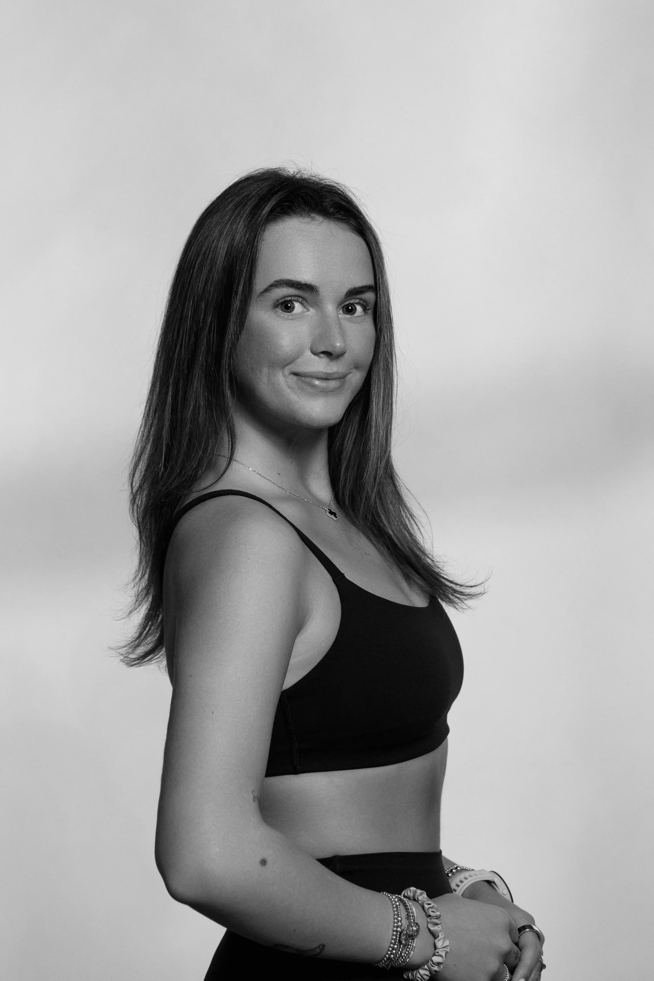 Black and White photo of a woman smiling with brown hair 