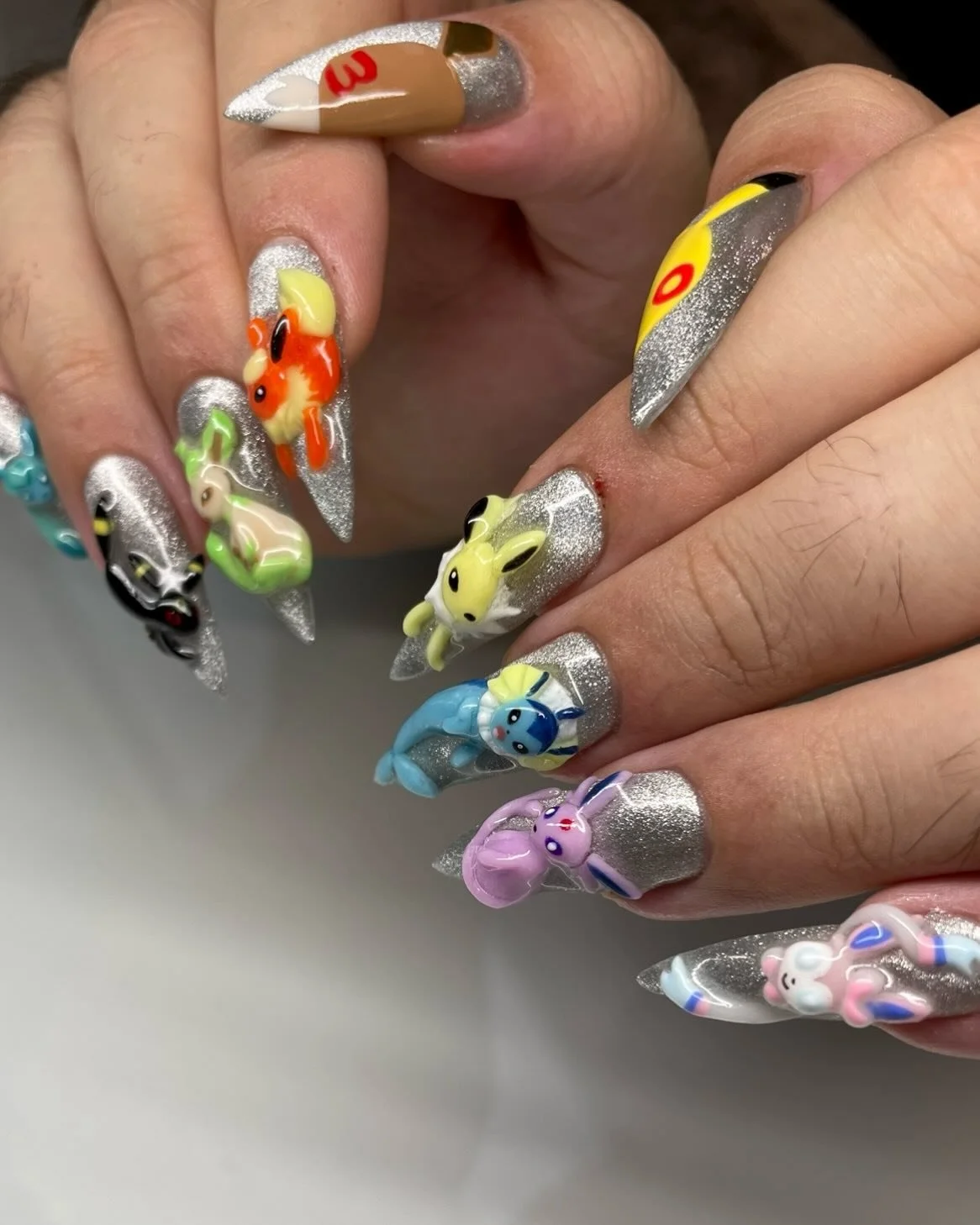 Photos of the Eeveelution set 💛🧡💙💜🖤💚🤍🩵

Never posted these so here they are :) still buzzing off these nails

I have a reel of how I made these if you&rsquo;re curious x

#eeveelution #pokemon #pokopia #nintendo #nailart