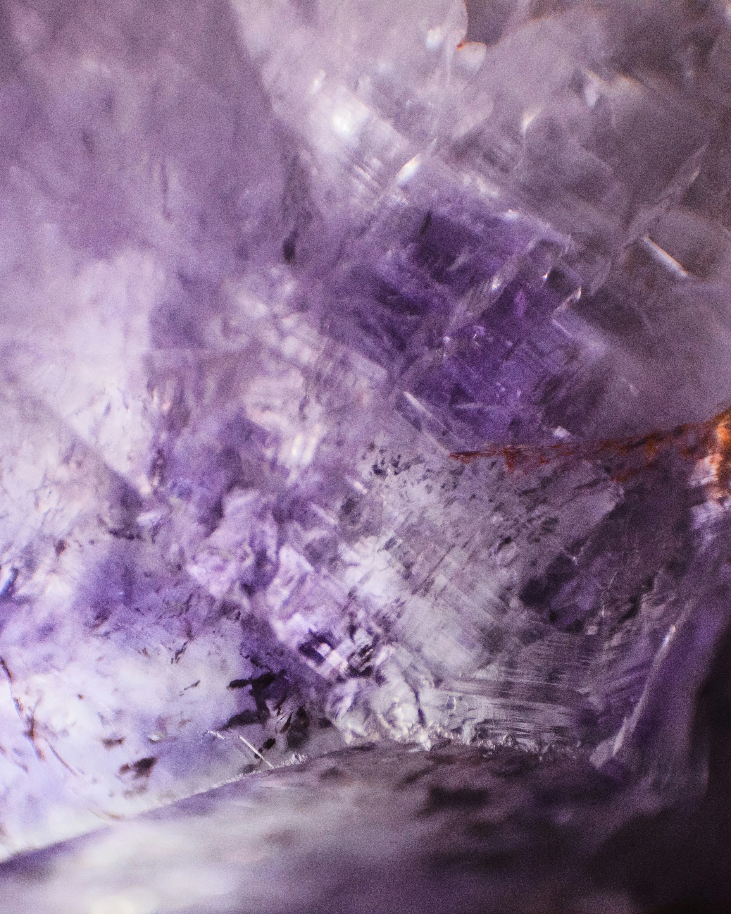 Close-up view inside a purple ice cave showing icy textures and formations.