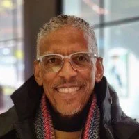 Smiling man wearing glasses Dr Sydney Gibbons, author