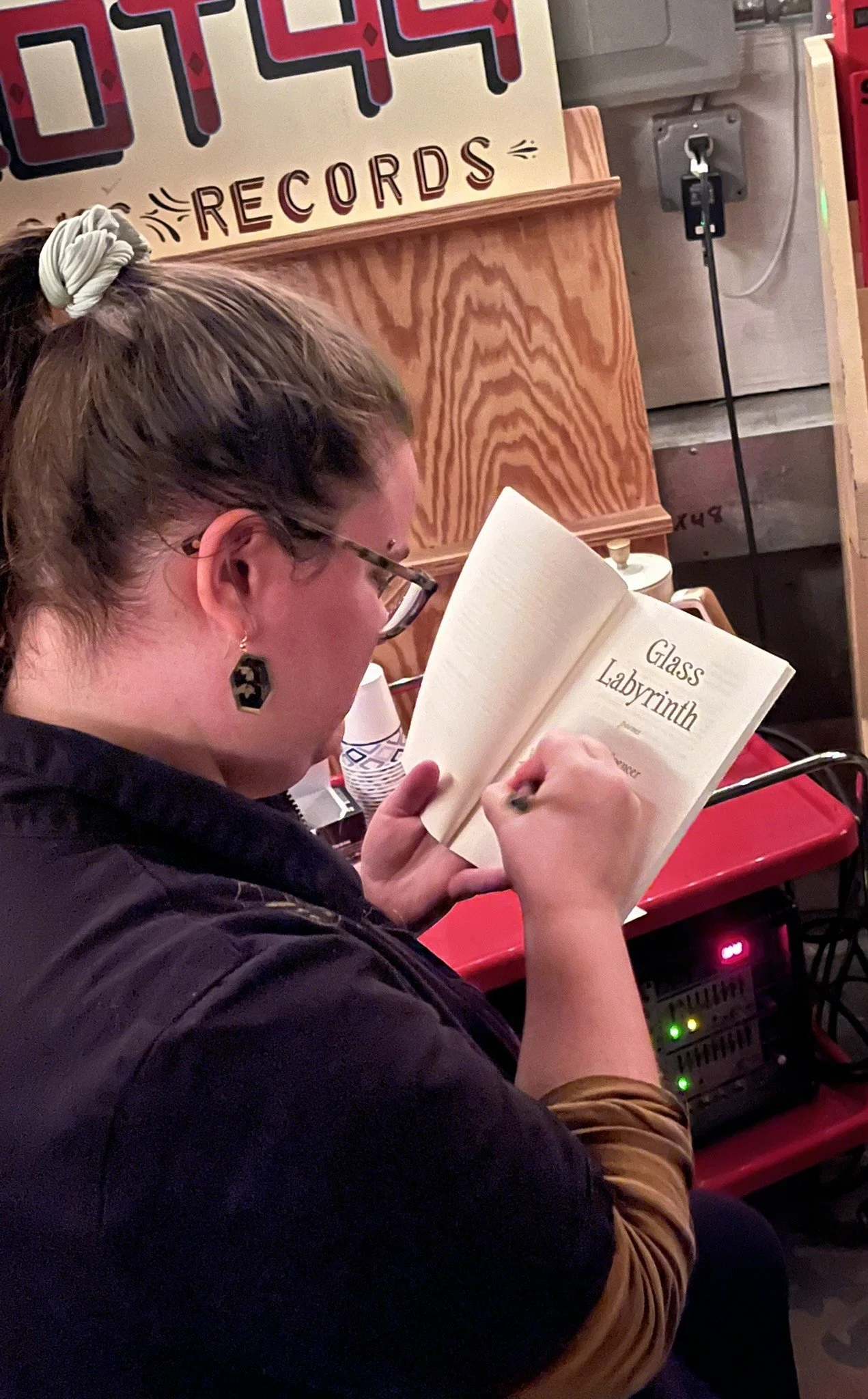 Hailey signing a copy of Glass Labyrinth at an event.