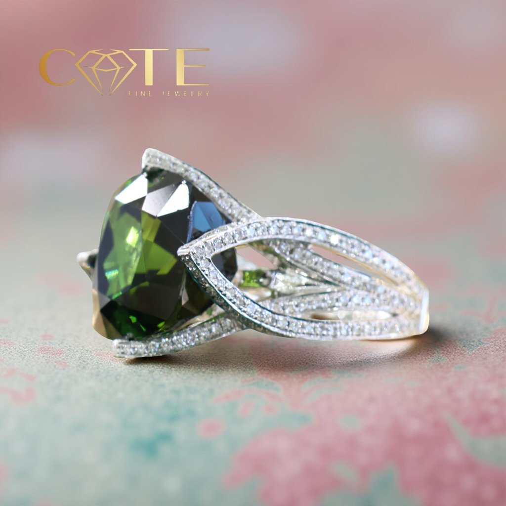This design features a stunning, deep green tourmaline as its centerpiece&mdash;a gemstone celebrated for its ability to promote emotional healing, balance, and clarity. Known as a stone of transformation, tourmaline is perfect for those entering a n
