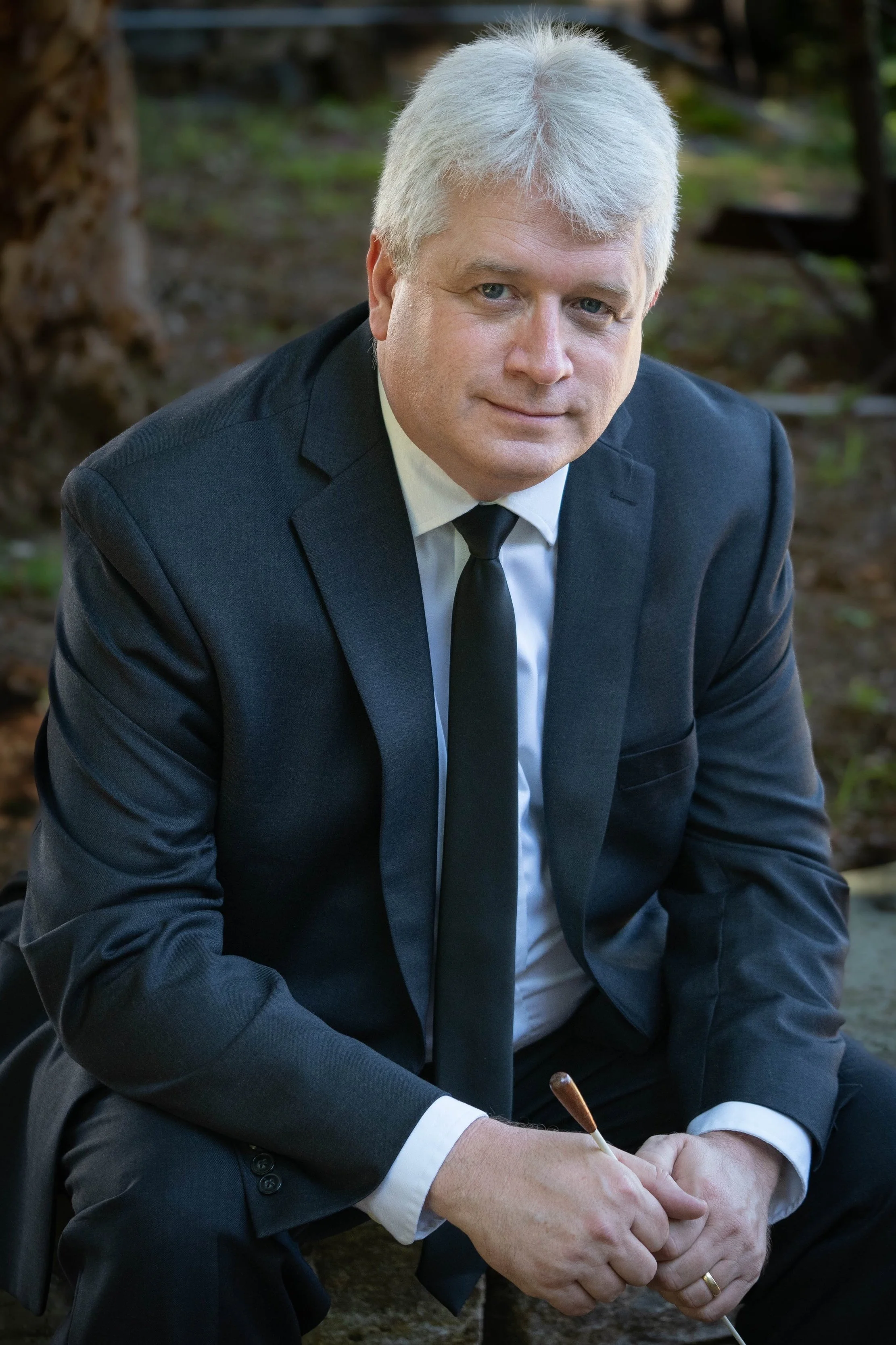 Portrait of David Upham in a black and white suit