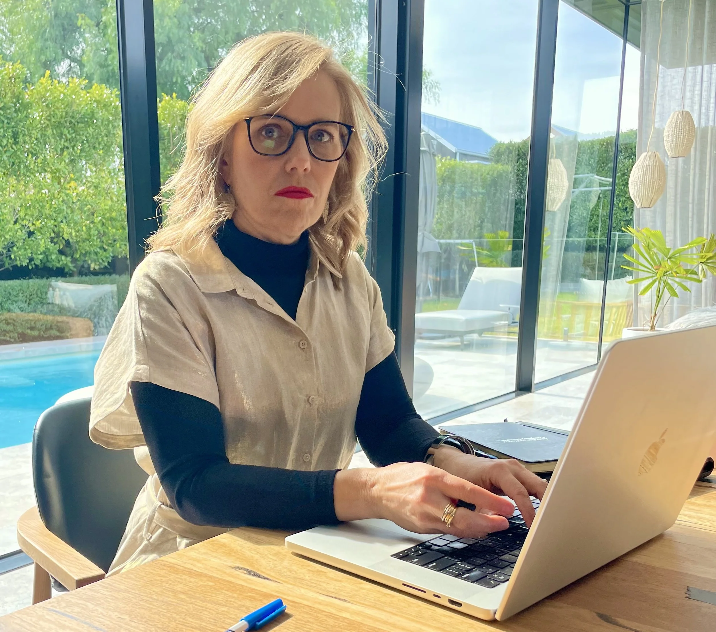 suzie thoraval sitting at a desk at a computer. Adaptive stability, adaptive leadership, leadership coaching, coach