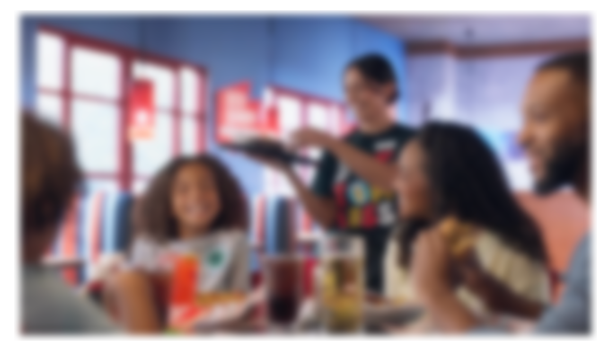 Red Robin ad with a family enjoying a nice, energetic meal at a Red Robin for the same price as eating fast food out of a bag in your car.