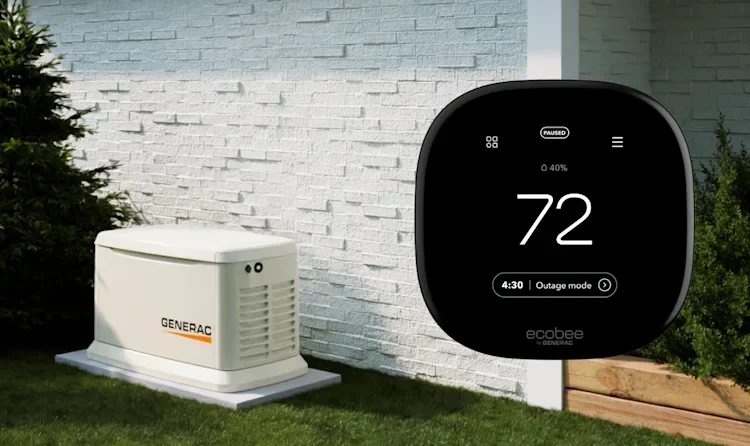 An outdoor Generac generator and an Ecobee thermostat showing a temperature of 72 degrees in a backyard next to a white brick wall and some greenery.