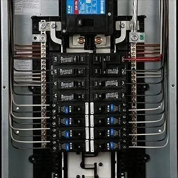 Electrical panel with circuit breakers and wiring.