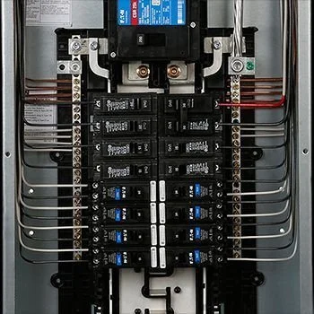 Electrical panel with circuit breakers and wiring.