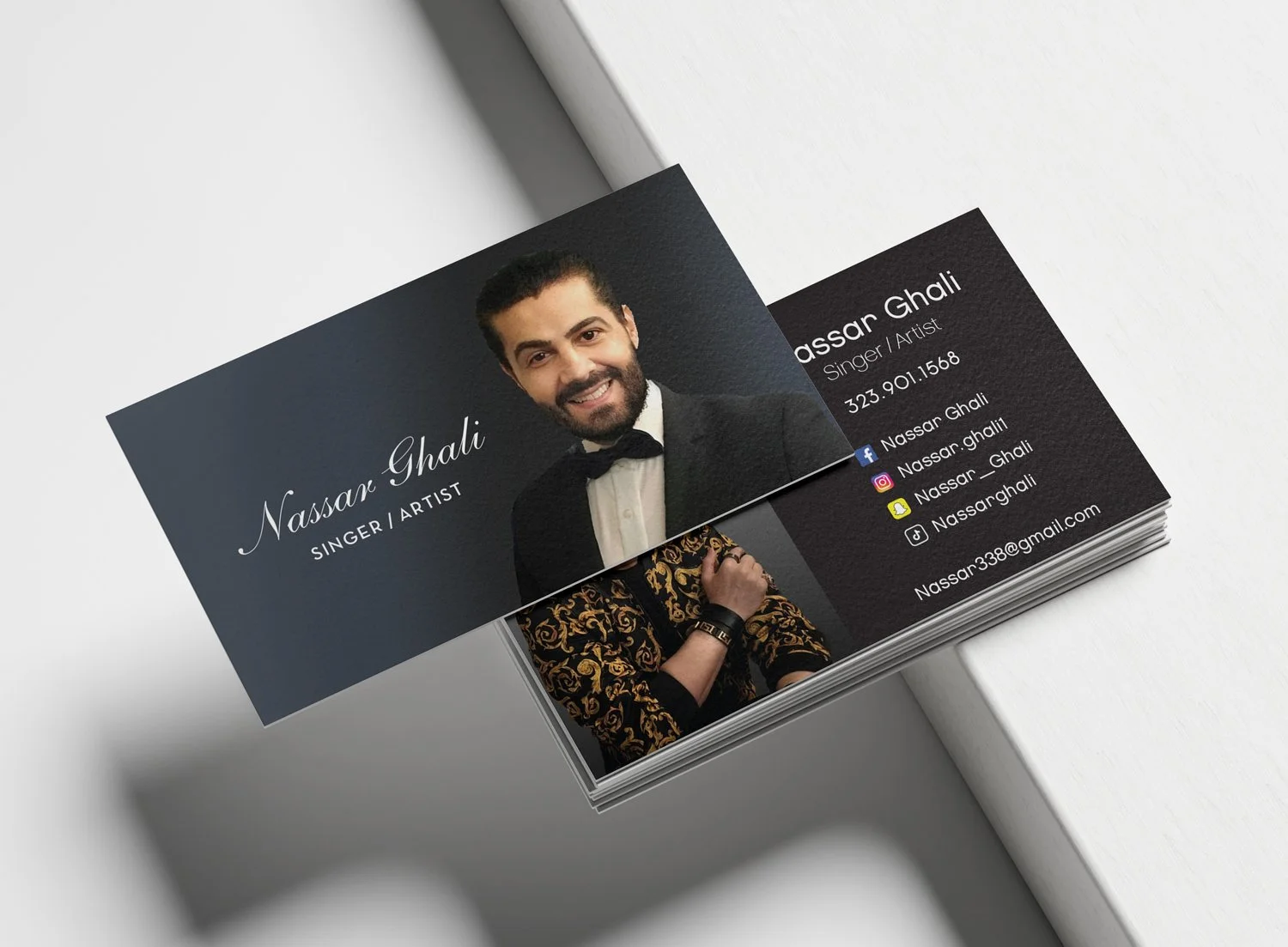 Business cards featuring a portrait of Nassar Ghalhi, a singer and artist, with contact information and social media icons.