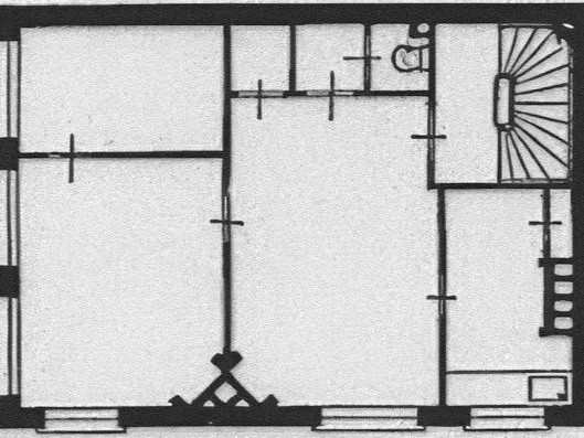 Black and white architectural floor plan showing rooms, a staircase, and a small bathroom with a toilet and sink.
