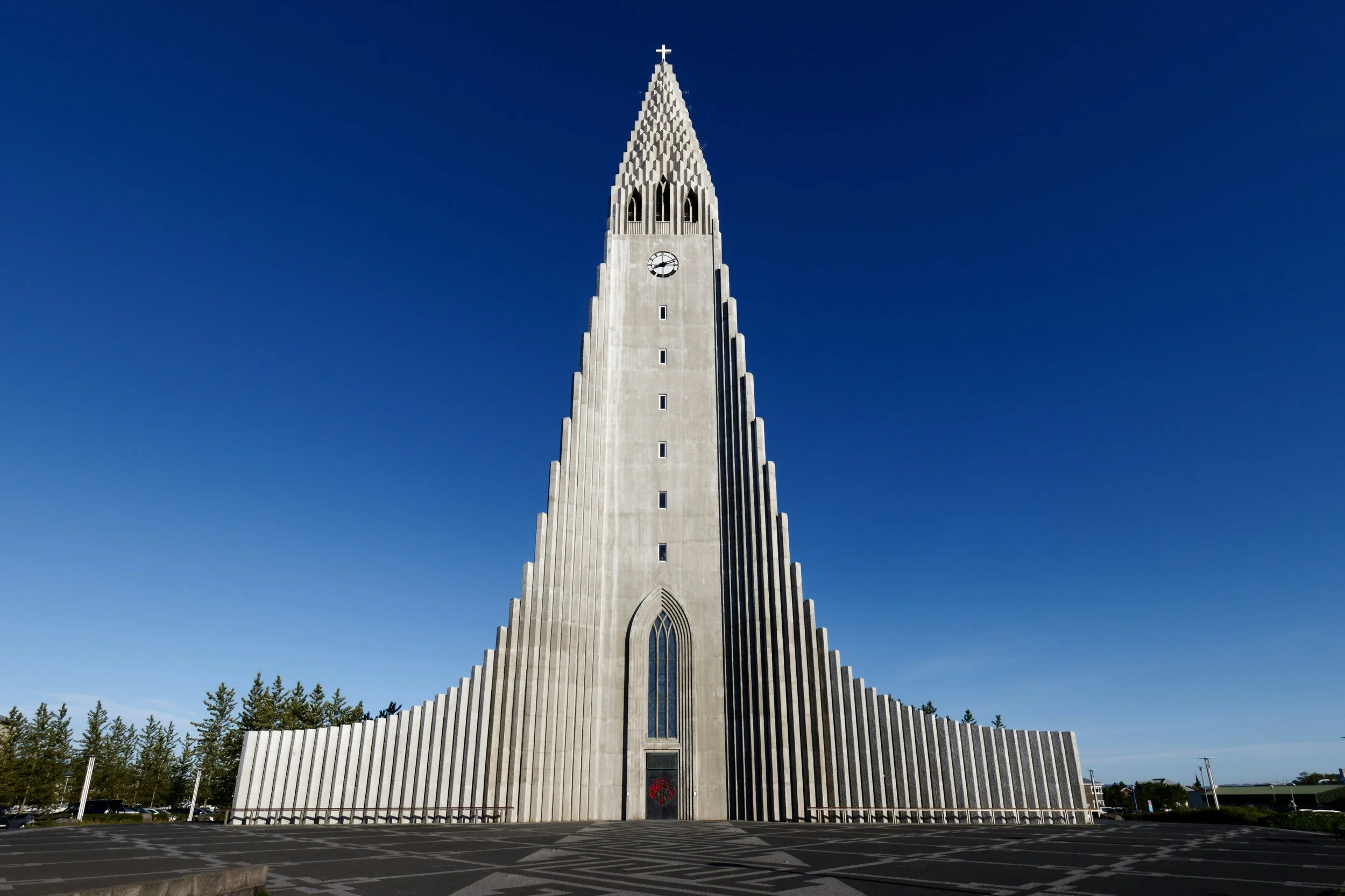The striking concrete spire of Hallgrímskirkja church rising against a clear blue sky in central Reykjavík, the northernmost capital city in the world, Iceland