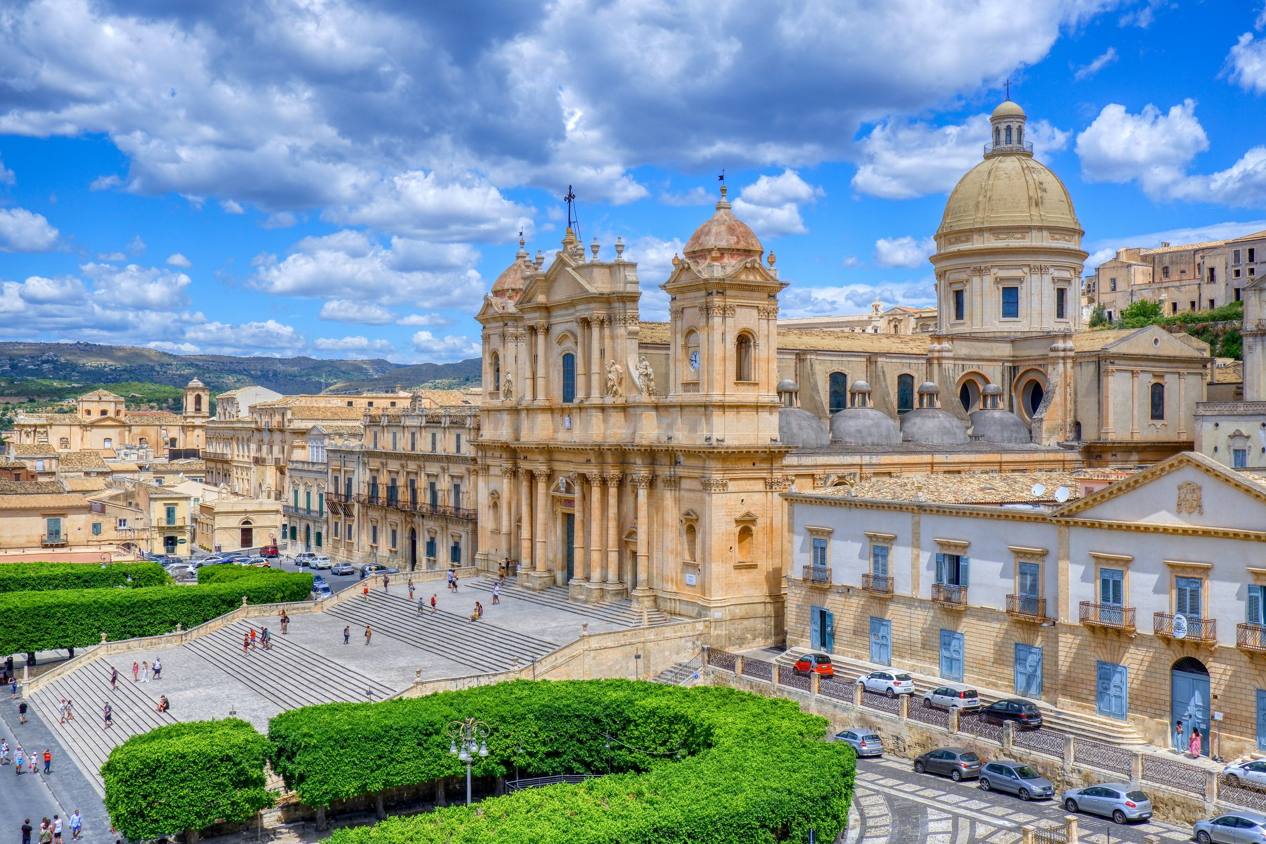 Aerial view of the honey-coloured baroque Noto Cathedral and its grand staircase in the UNESCO-listed town of Noto, Sicily, Italy