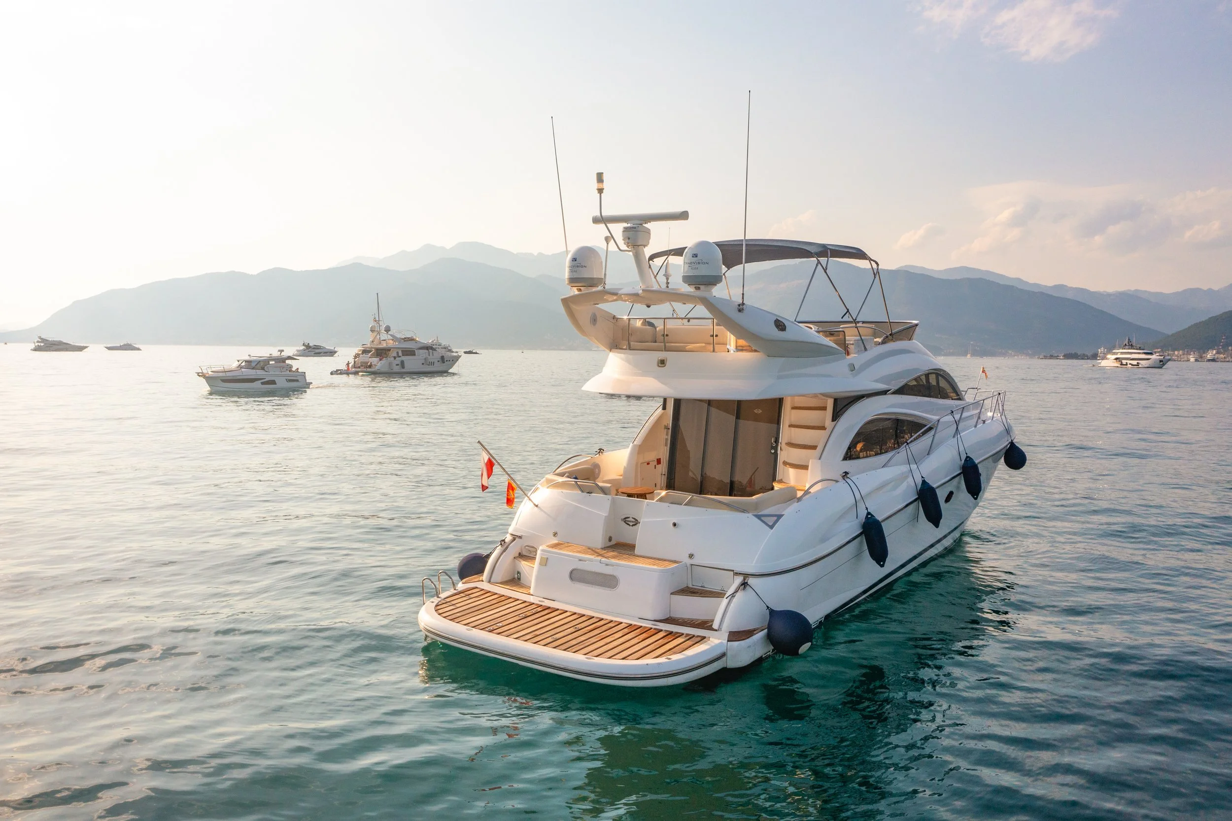 Private motor yacht anchored in the Albanian Riviera with mountains in the background