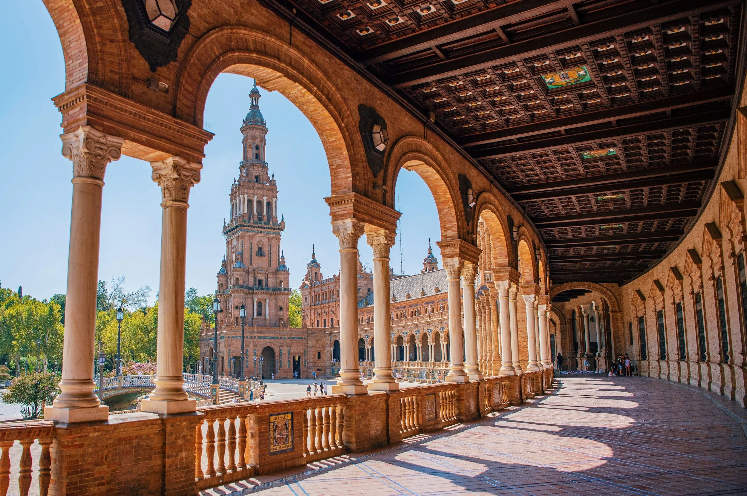 The colonnaded arcade and tower of Plaza de España in Seville on a clear sunny day, Andalusia, Spain