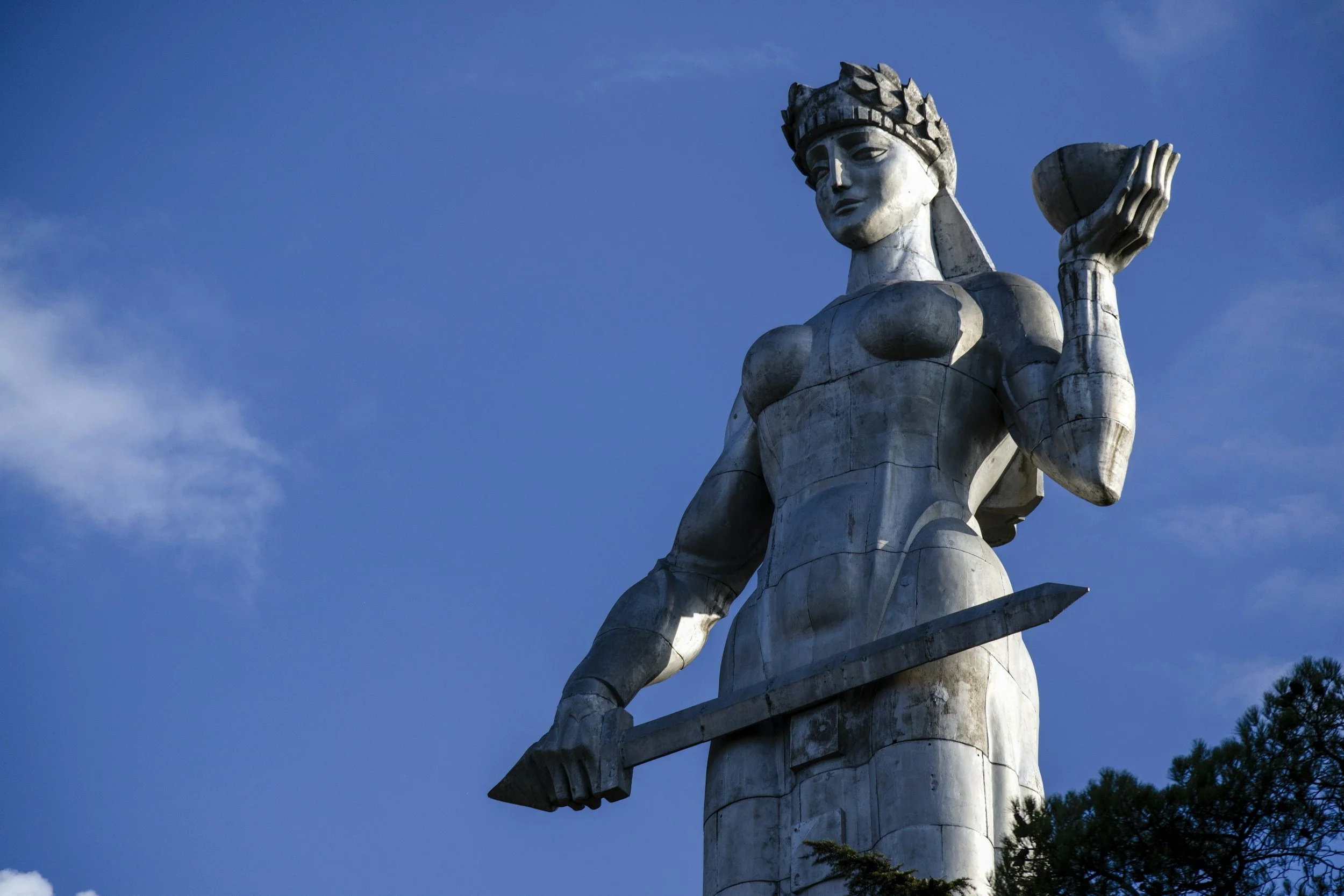 The aluminium figure of Kartlis Deda the Mother of Georgia holding a sword and a bowl of wine on a hilltop above Tbilisi, Georgia