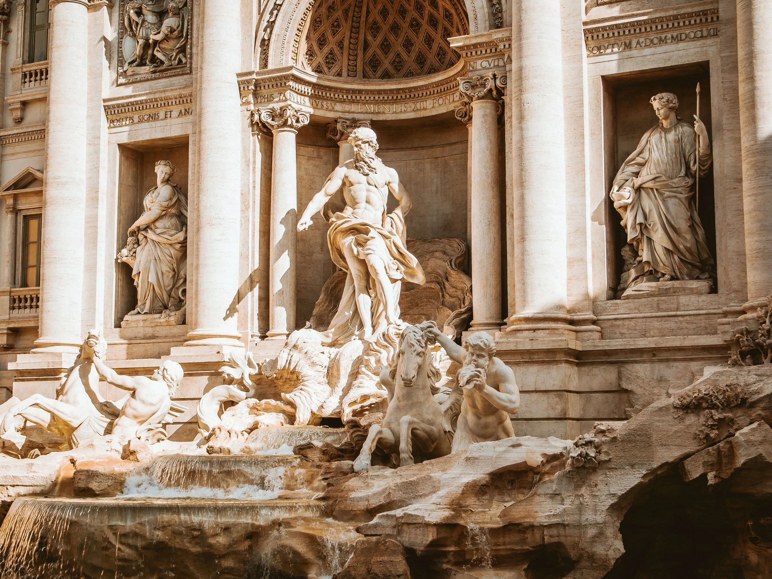 The central Neptune sculpture and cascading water of the Trevi Fountain in Rome, the largest Baroque fountain in the city and one of Italy's most celebrated landmarks