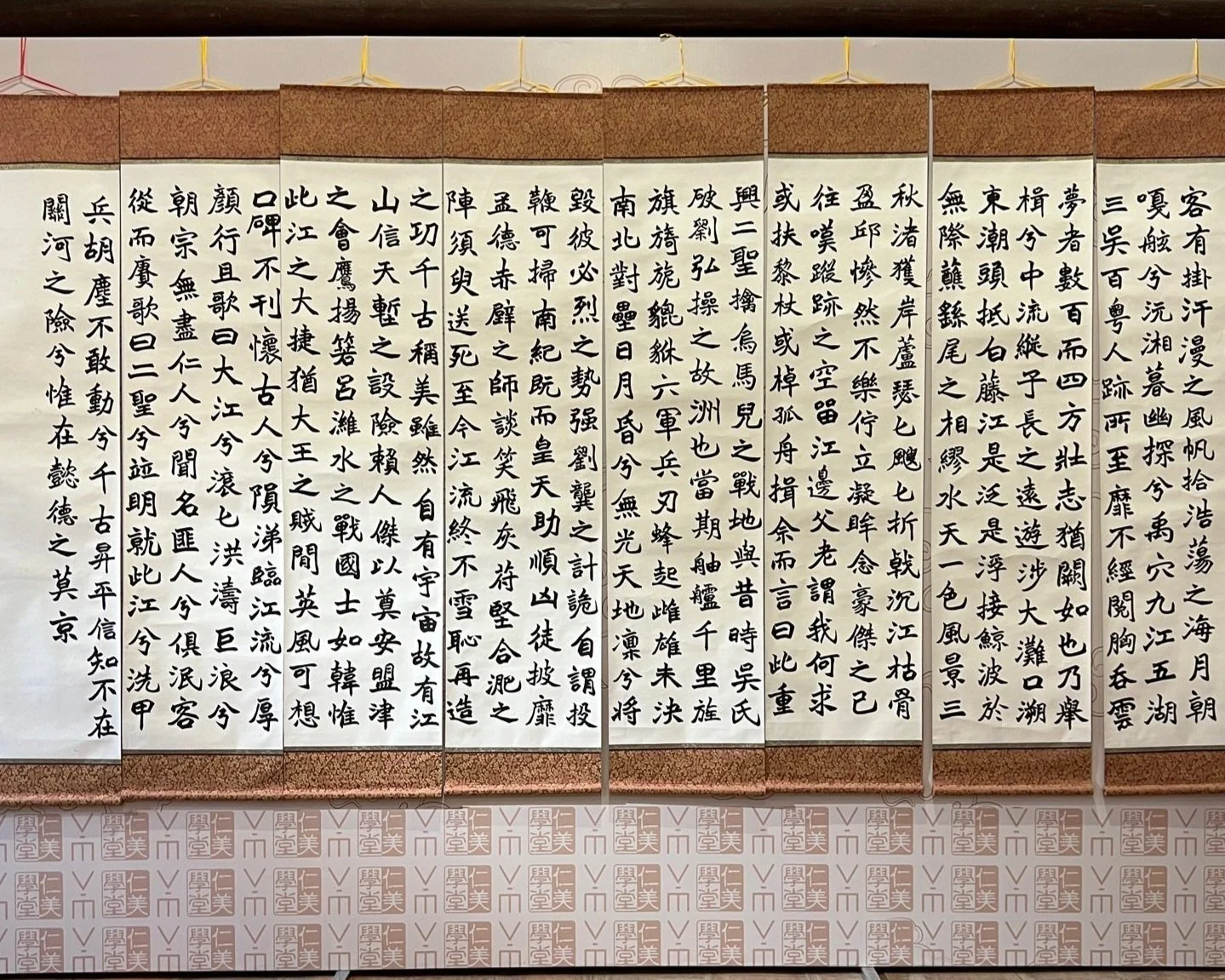 Rows of traditional Vietnamese calligraphy scrolls with Chinese characters displayed on hanging panels on a wall in Hanoi, representing the city's literary and scholarly heritage