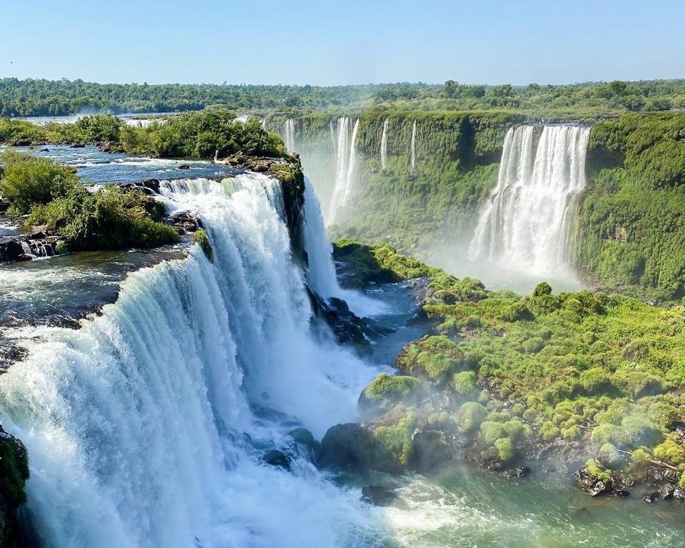 The thundering cascades of Iguazú Falls viewed from the walkways beside the Devil's Throat, with mist rising and the surrounding rainforest visible, Argentina