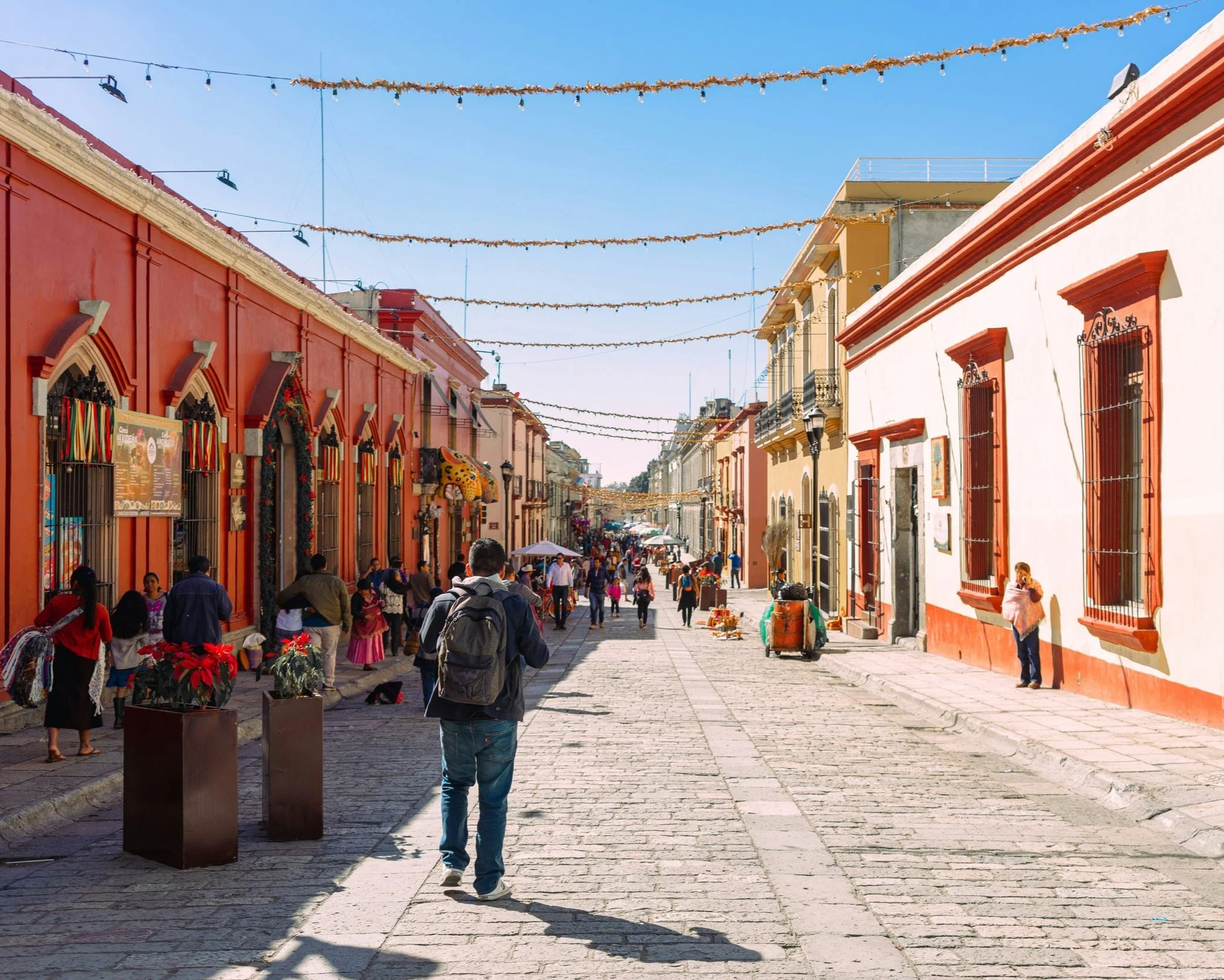 Colourful colonial streetscape with pedestrians in the historic centre of Oaxaca on a private tour of Mexico