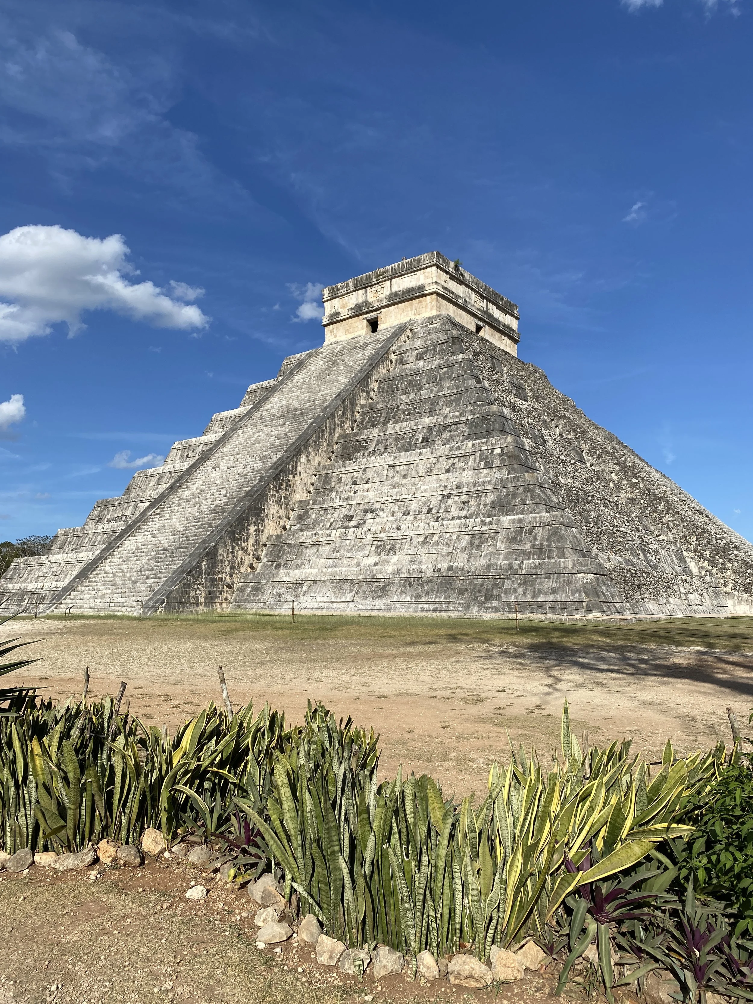 The stepped pyramid of El Castillo at Chichén Itzá under a blue sky on a private exclusive access tour of the Mayan ruins, Mexico