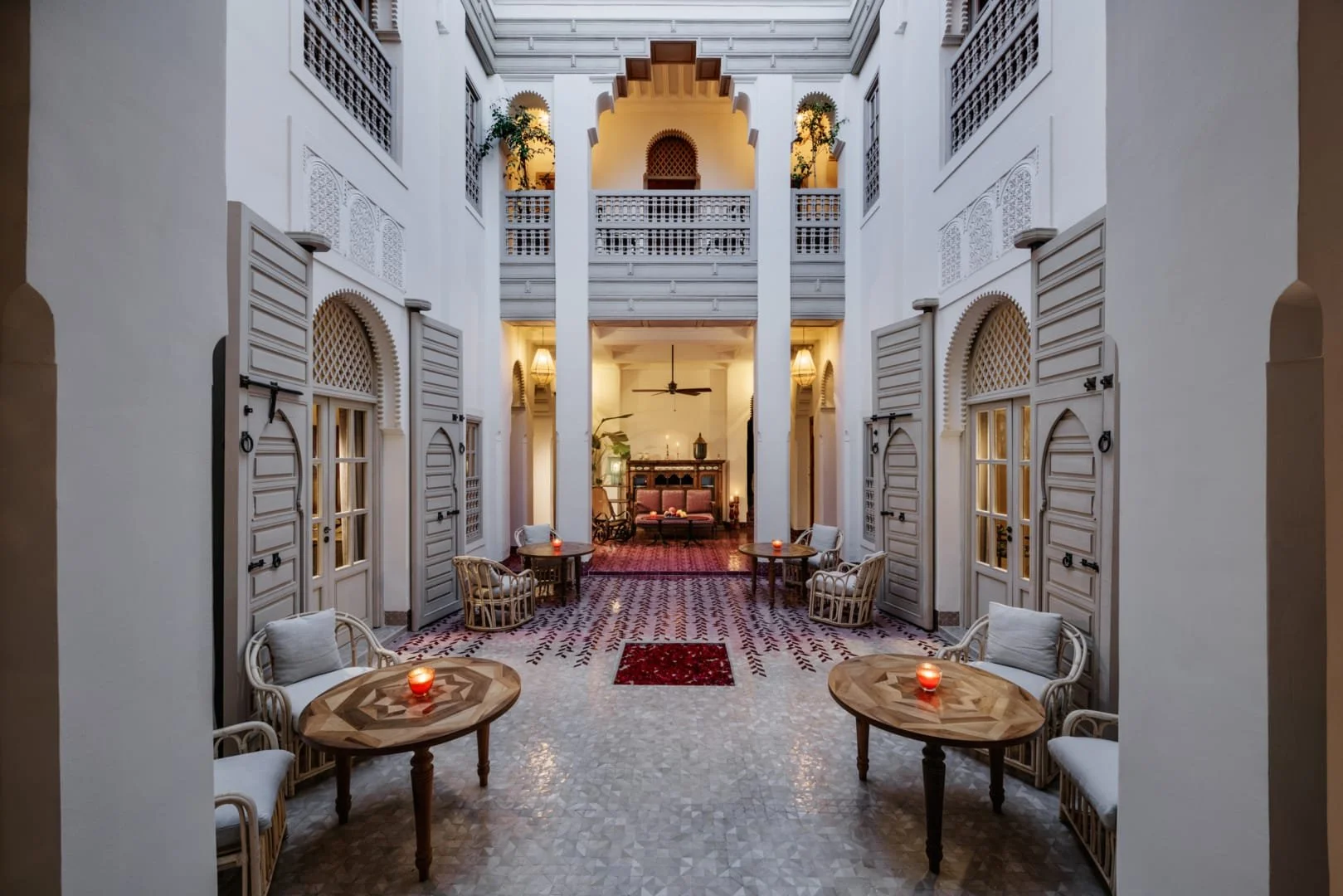 Elegant riad courtyard in Marrakech with hand-painted tilework, arched galleries and lantern lighting