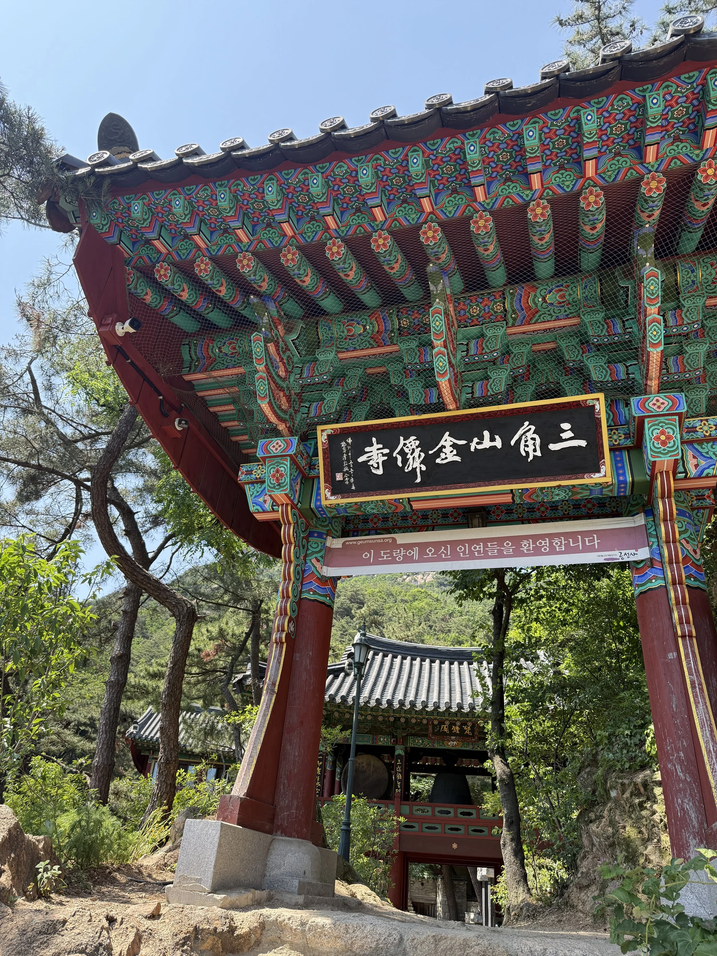 Ornately painted gate of a Buddhist temple in the mountains of South Korea on a private temple stay experience