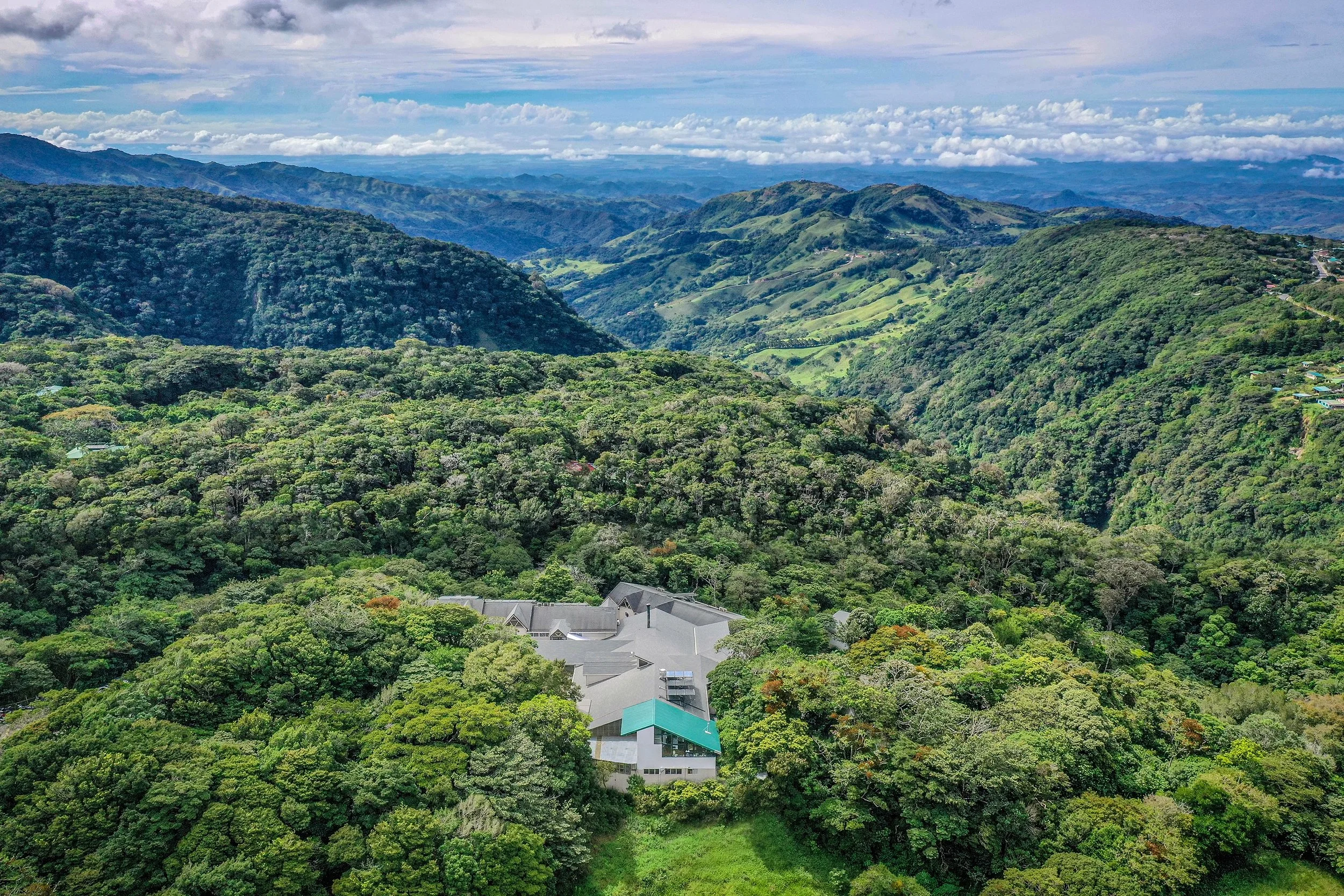 Aerial view of a lodge surrounded by the rolling misty canopy of the Monteverde cloud forest, Costa Rica