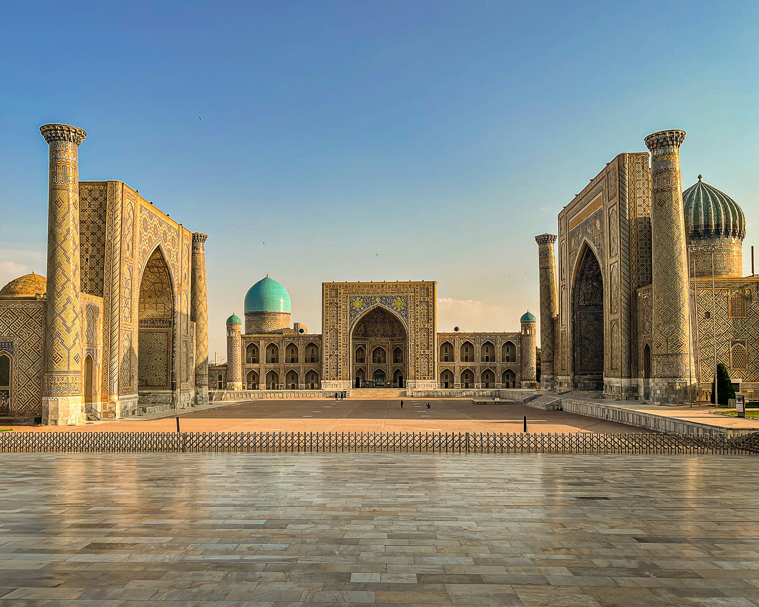 The three mosaic-covered madrasas of the Registan in Samarkand at sunrise on a private Silk Road journey through Uzbekistan