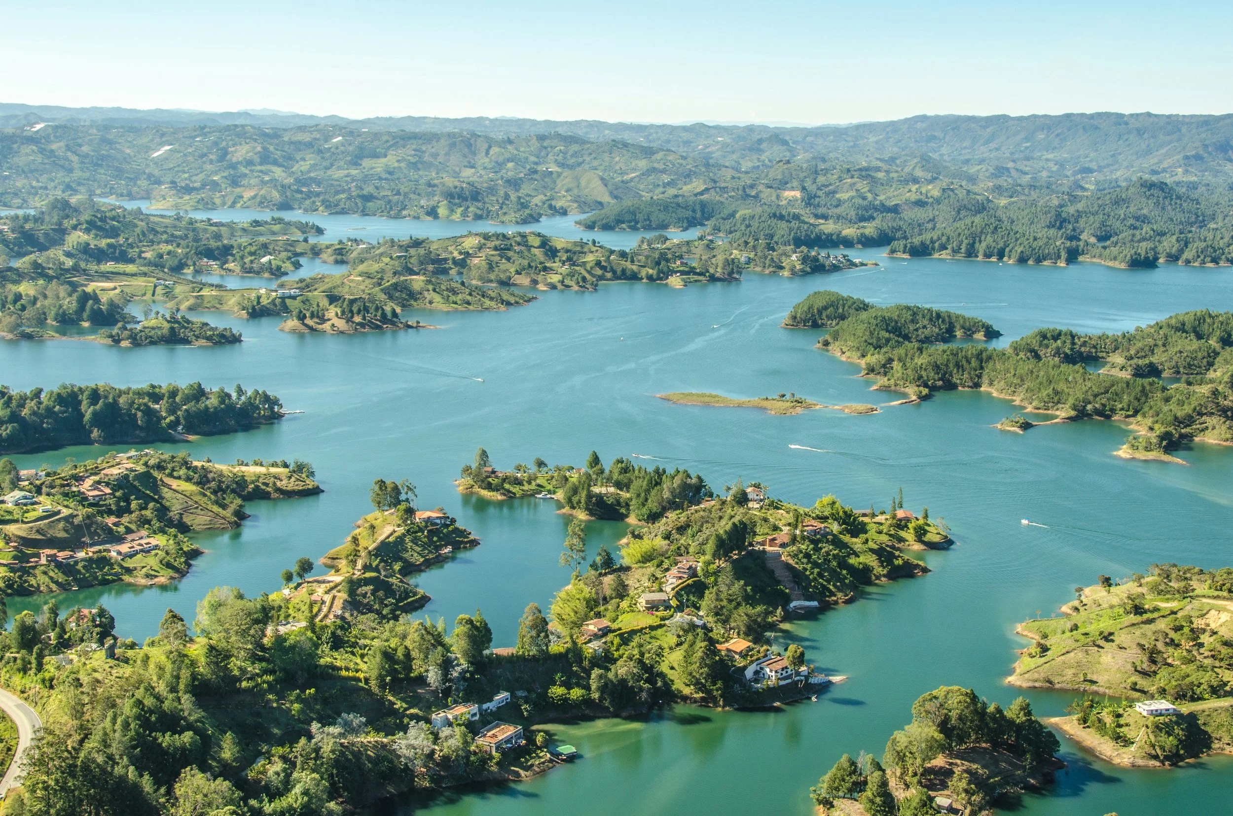 Aerial view of the maze-like green islands and turquoise waters of the Guatapé reservoir near Medellín, Colombia
