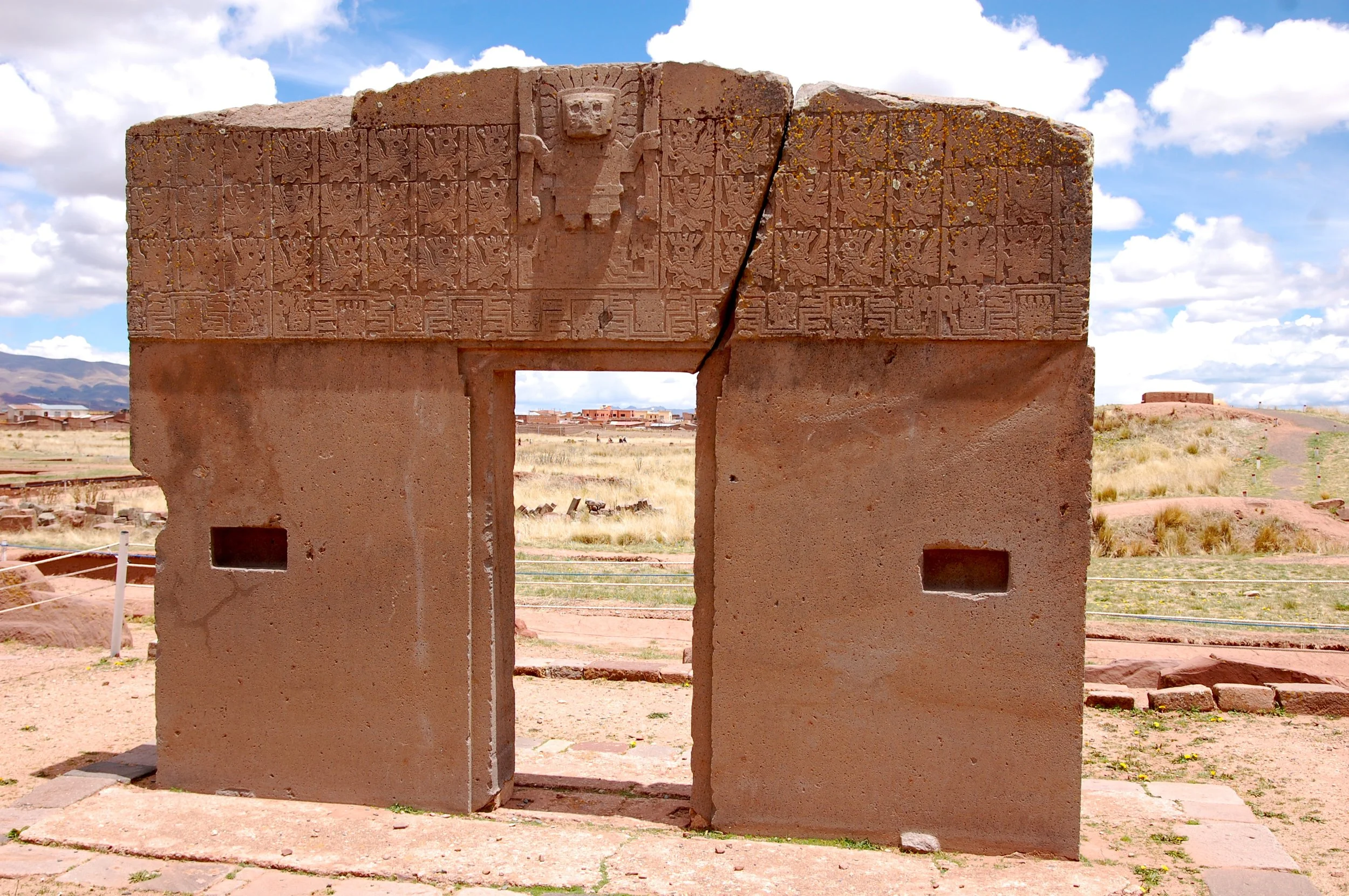 The carved stone Gateway of the Sun at the ancient Tiahuanaco archaeological site on the Bolivian altiplano under a bright blue sky