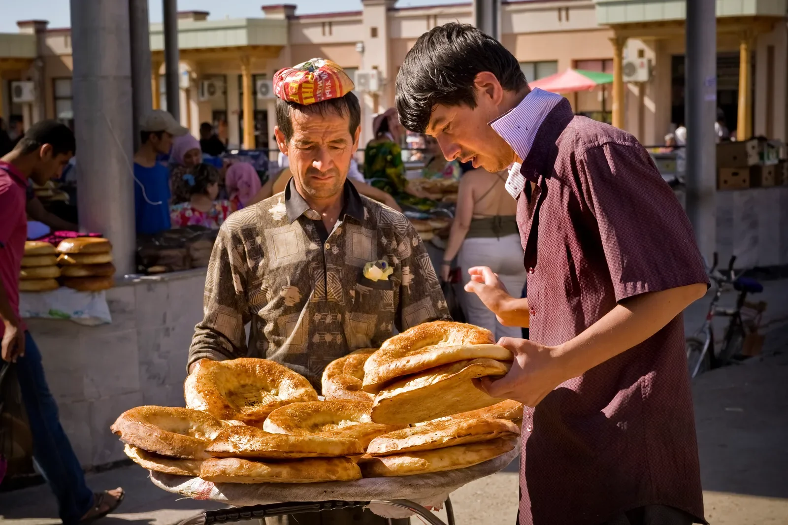 Colourful spice stalls and dried fruit vendors in a traditional Uzbek bazaar on a private food tour