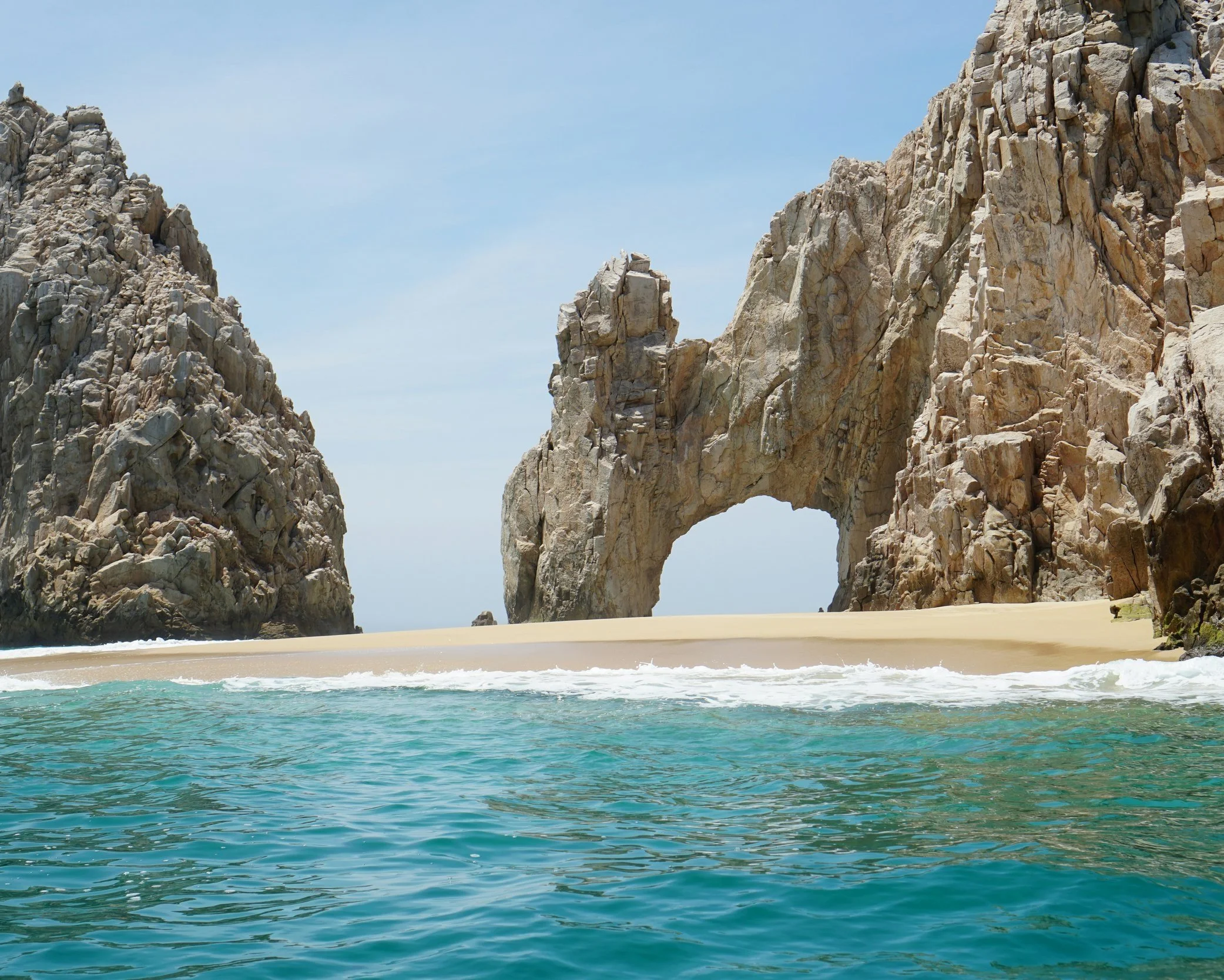 The iconic rock arch of El Arco rising from the sea at the tip of the Baja California Peninsula in Los Cabos, Mexico
