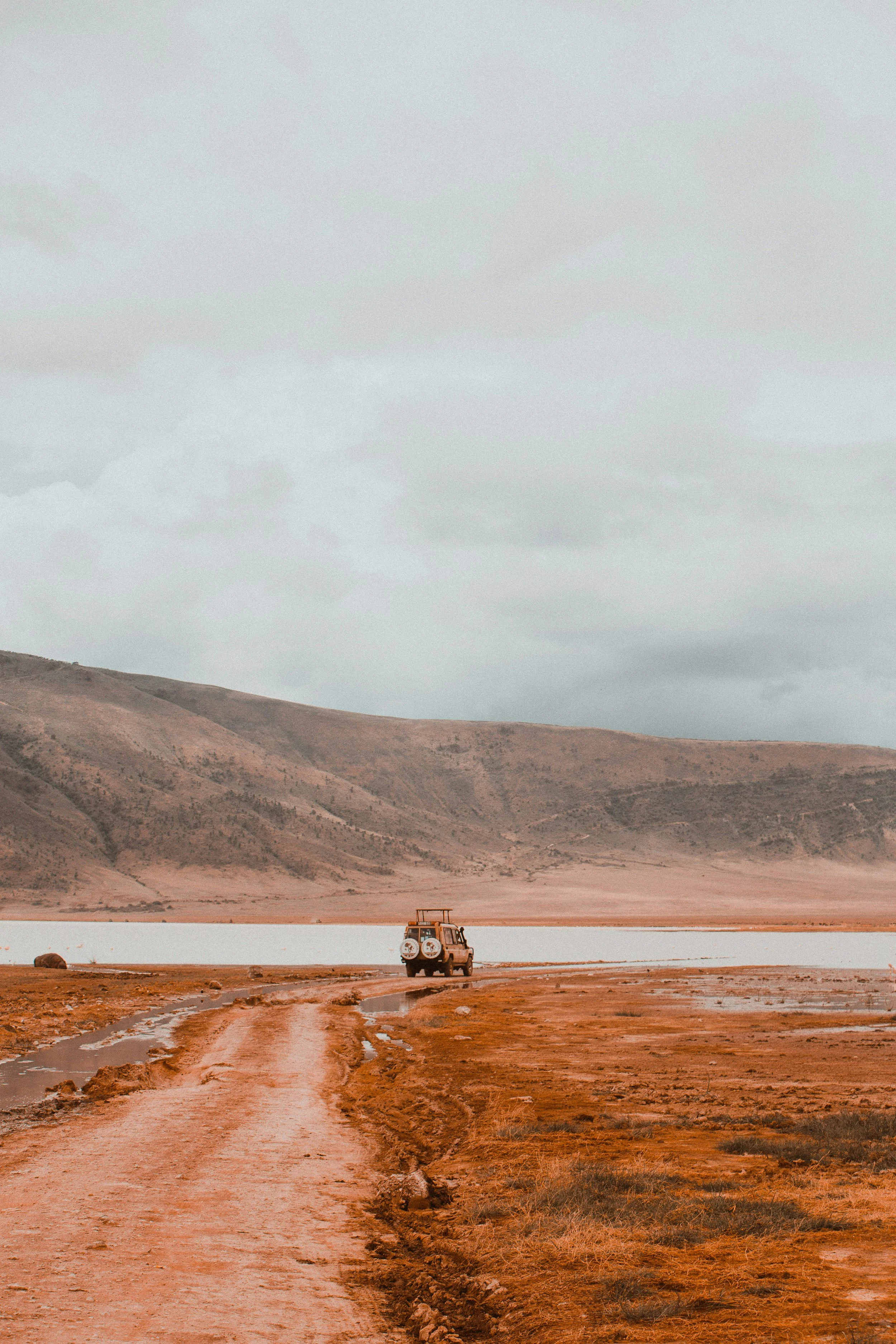 Private safari vehicle on a red dirt track inside the Ngorongoro Crater, Tanzania