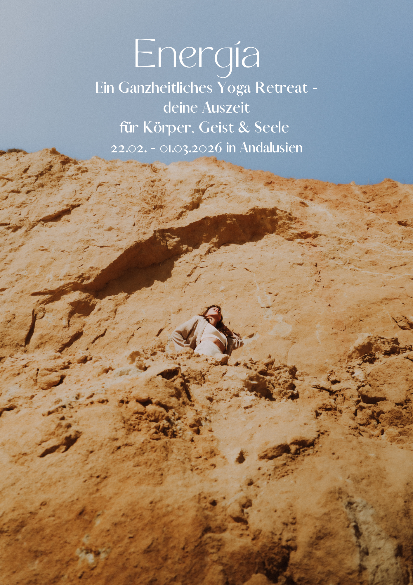 A woman in light clothing stands on a sandy, rocky landscape with large sandstone formations and bright blue sky.