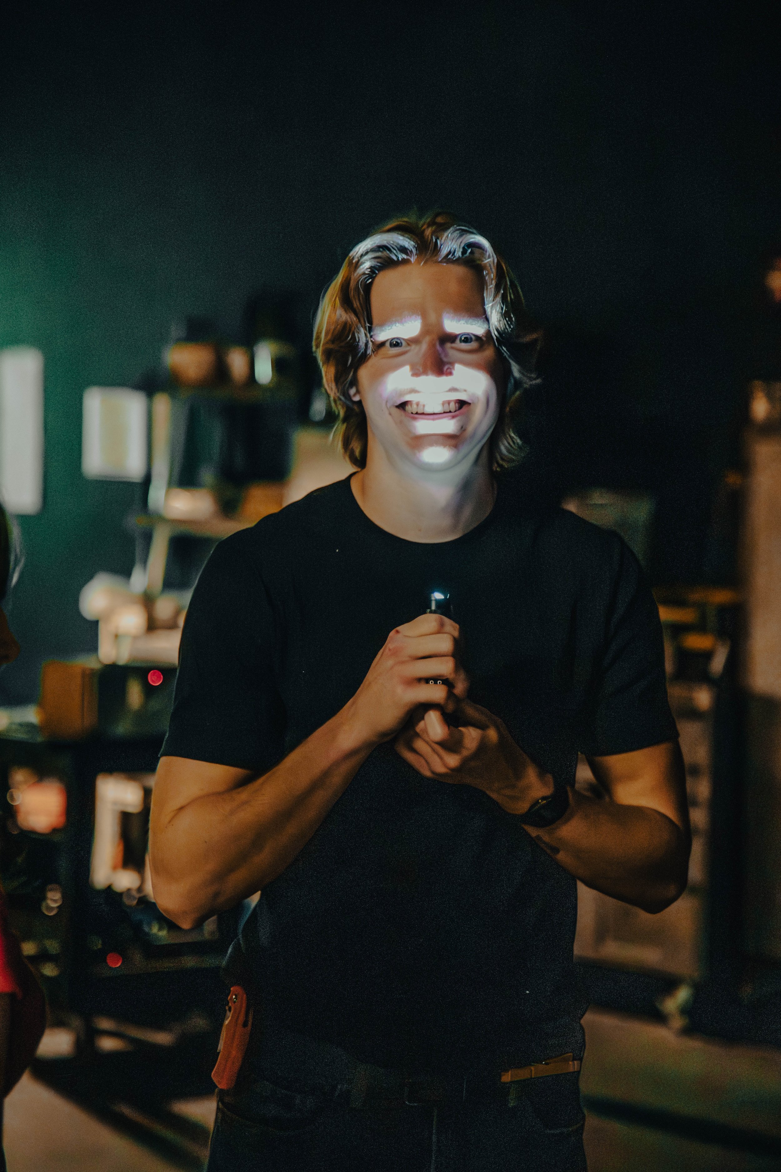 Ian Haigler smiles with a flashlight