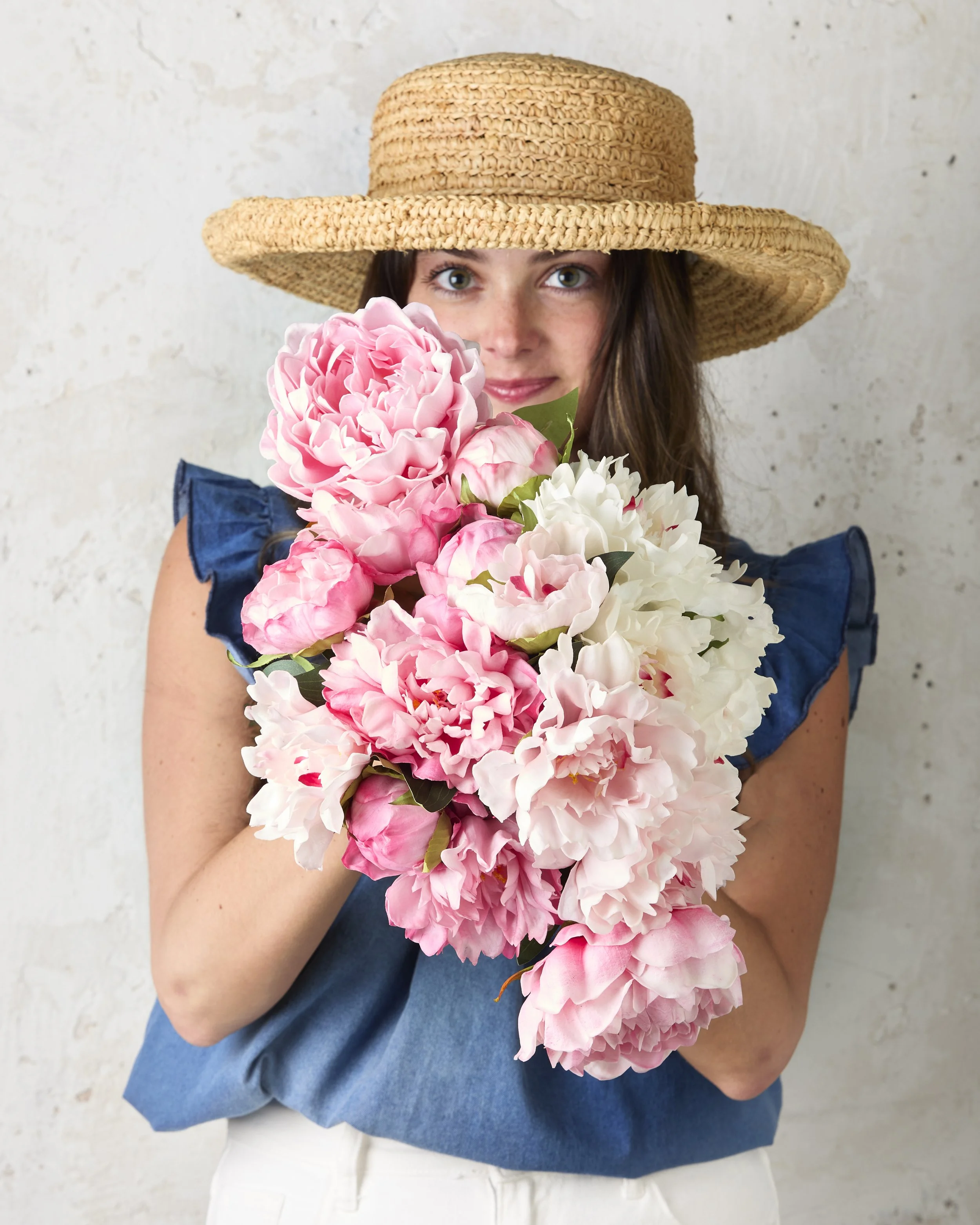 girl in a straw hat holding flowers, fresh-cut flowers, pink flowers