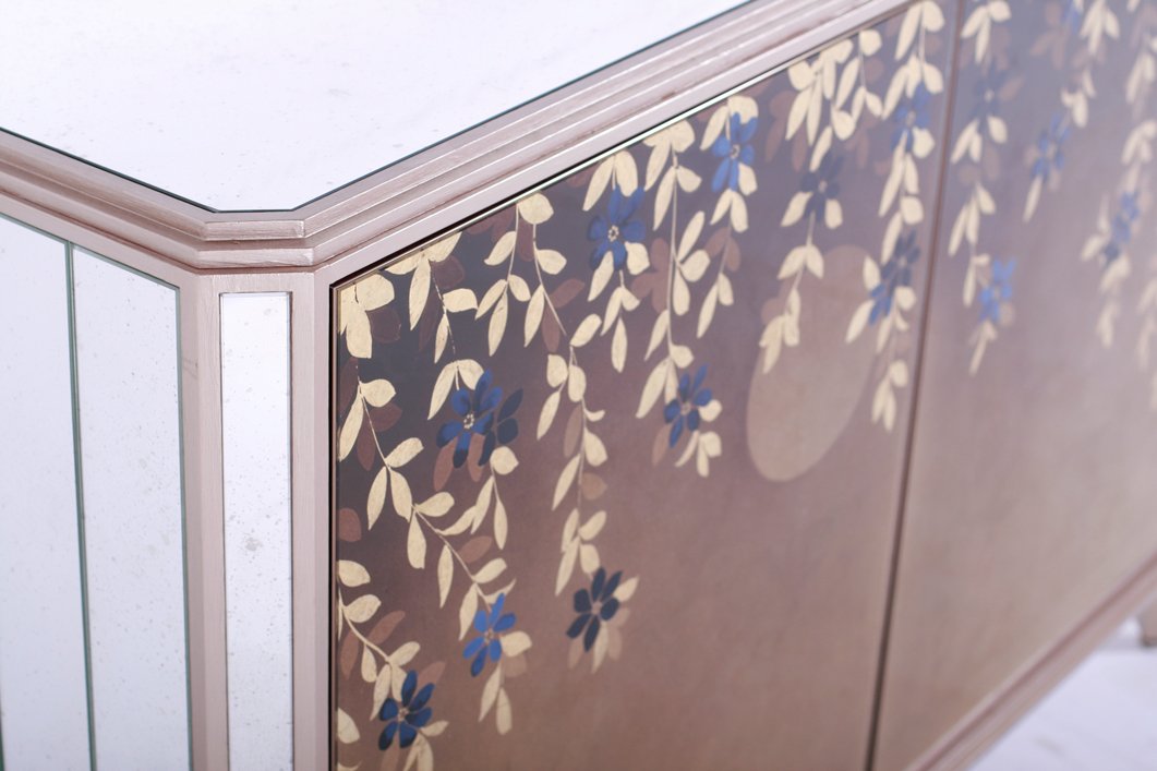 Corner detail of an eglomise sideboard with hand painted detailing. For interior designers, joinery and furniture manufacturers and private individuals.