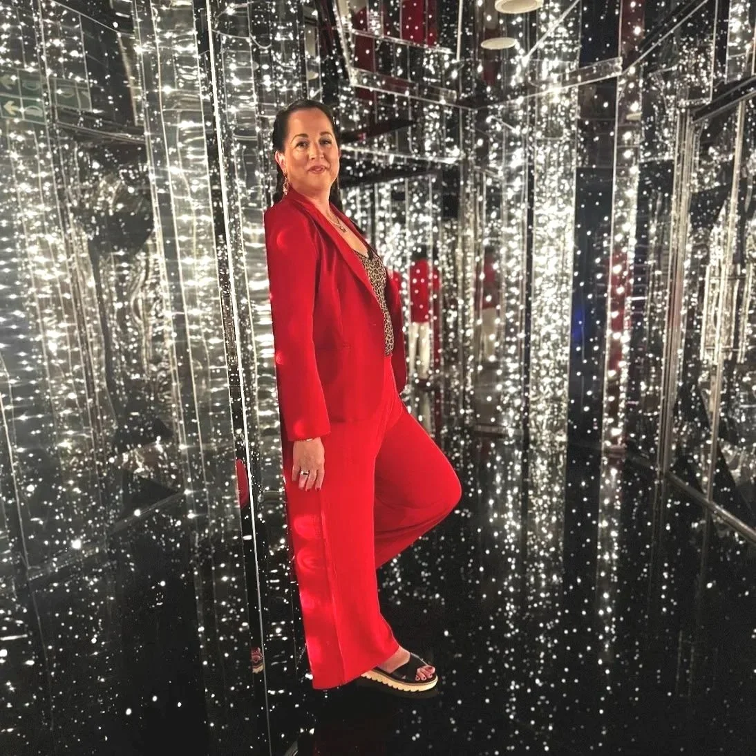 Celeste Woodside, Gold Tier First Mate and Virgin Voyages travel advisor, dressed in red for Scarlet Night aboard a Virgin Voyages ship