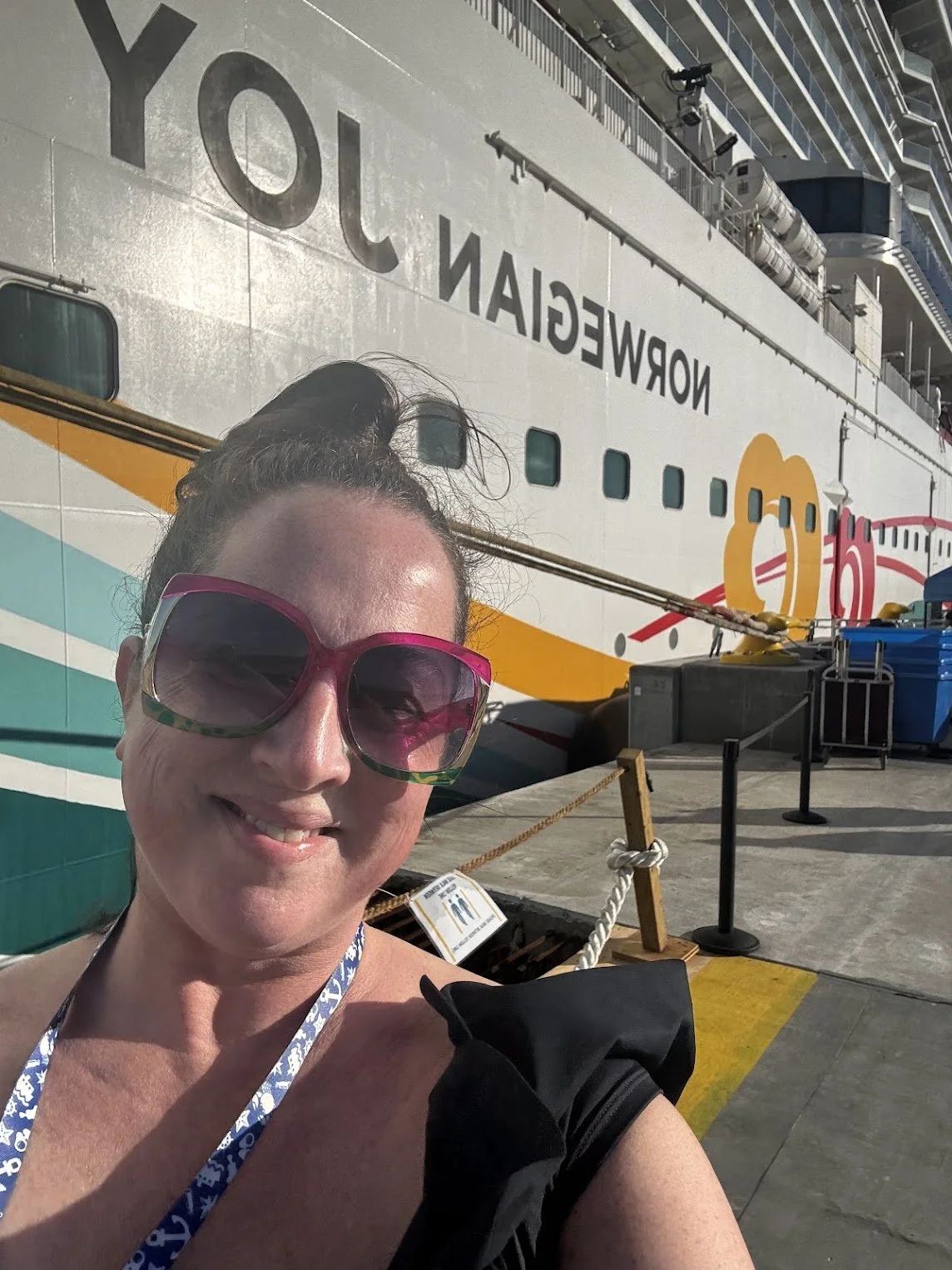 Celeste Woodside, travel advisor standing in front of a Norwegian Cruise Line ship.