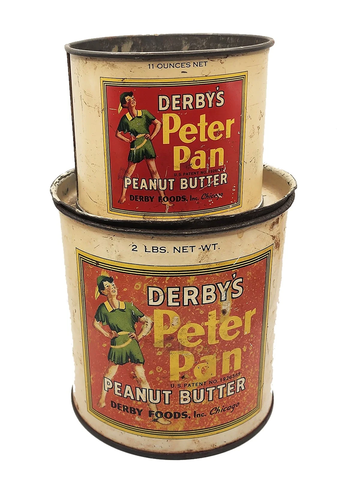 Two vintage cans of Derby's Peter Pan peanut butter stacked on top of each other, showing an original red and yellow label with a woman in a green dress.